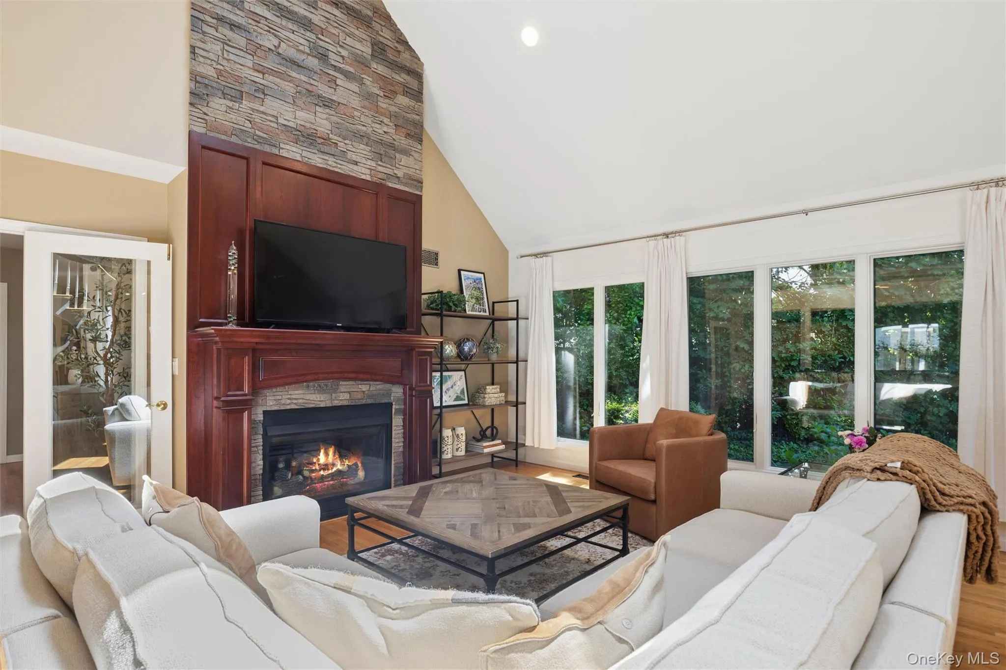 Stunning Cherry wood (gas) fireplace mantle with stacked surround stone. Stunning Cherry wood (gas) fireplace mantle with stacked surround stone.