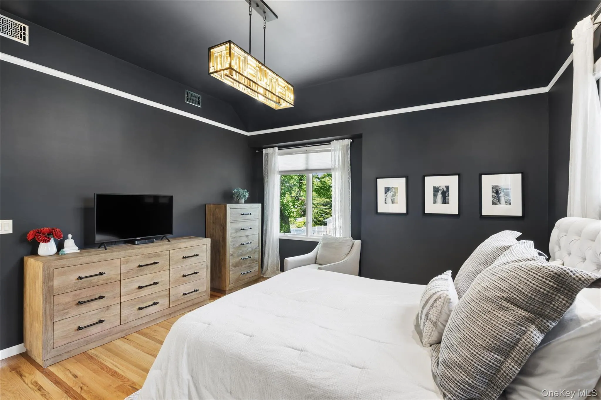 Primary Bedroom with hardwood floors and custom cathedral ceiling Primary Bedroom with hardwood floors and custom cathedral ceiling