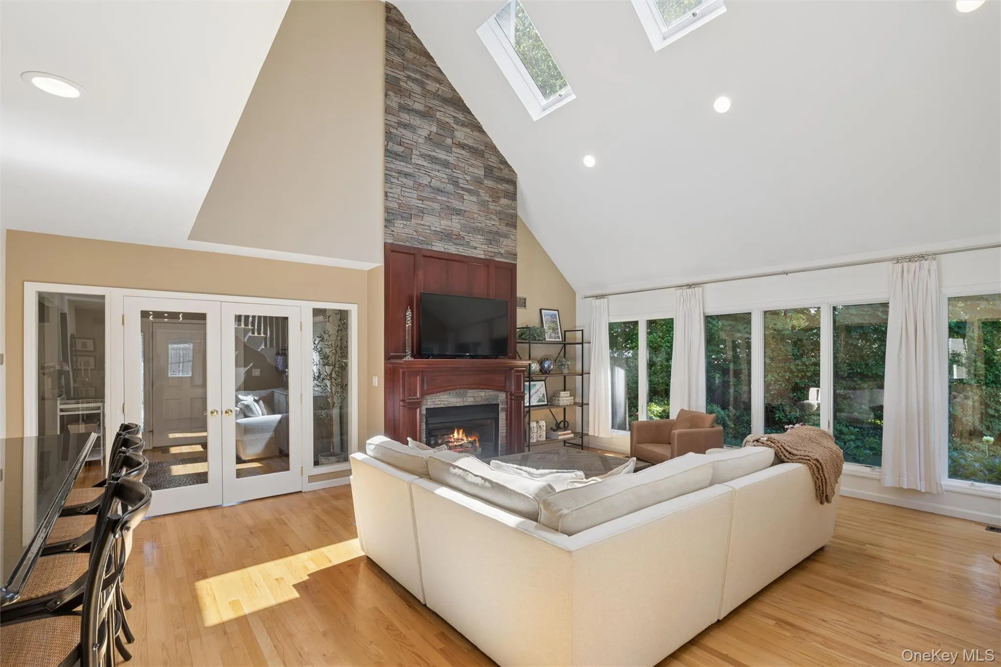 Hardwood floors, walls of windows and beautiful cherry wood mantle (gas) fireplace Hardwood floors, walls of windows and beautiful cherry wood mantle (gas) fireplace