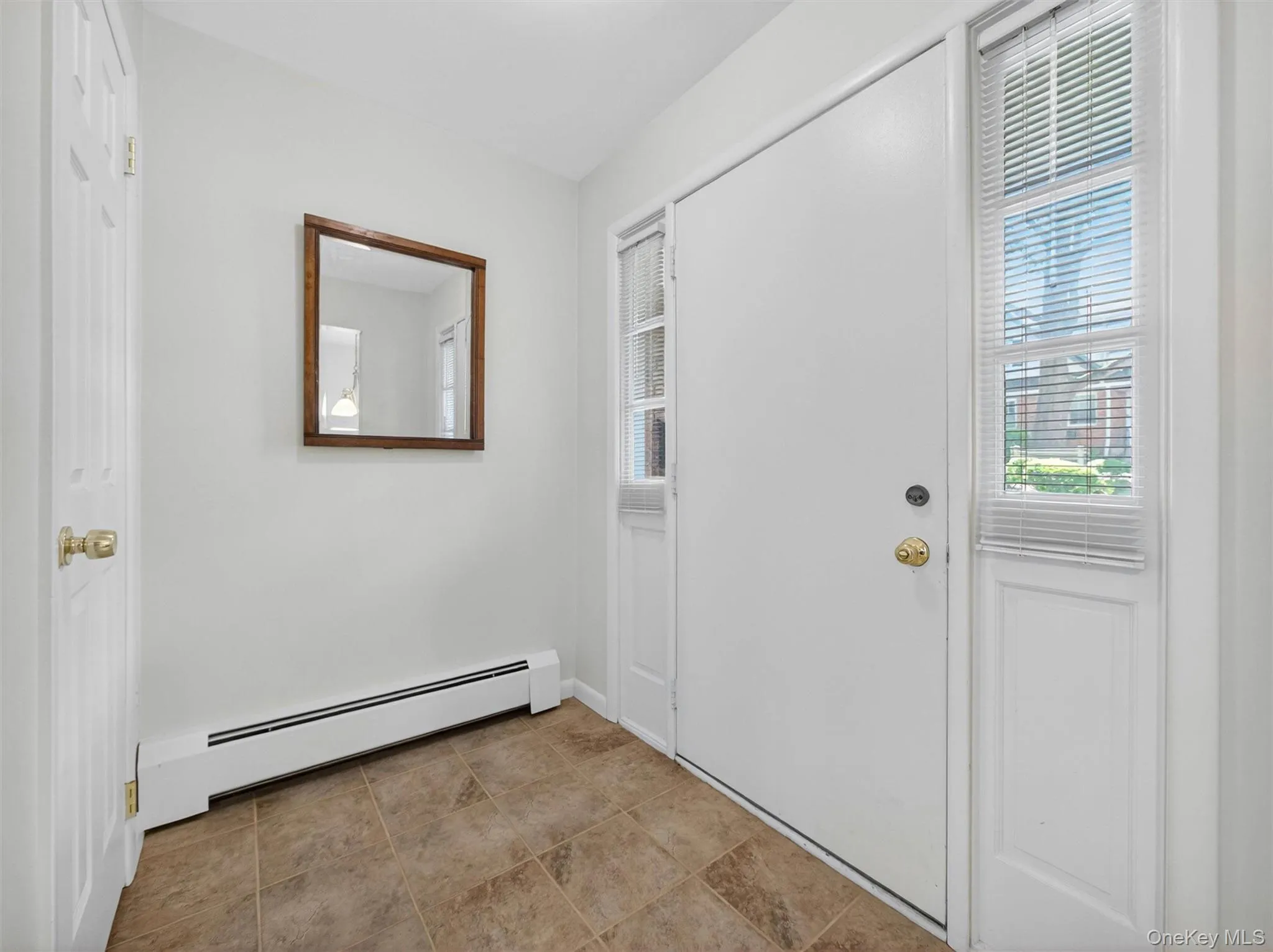 Welcoming foyer with convenient coat closet and durable tile flooring. Welcoming foyer with convenient coat closet and durable tile flooring.