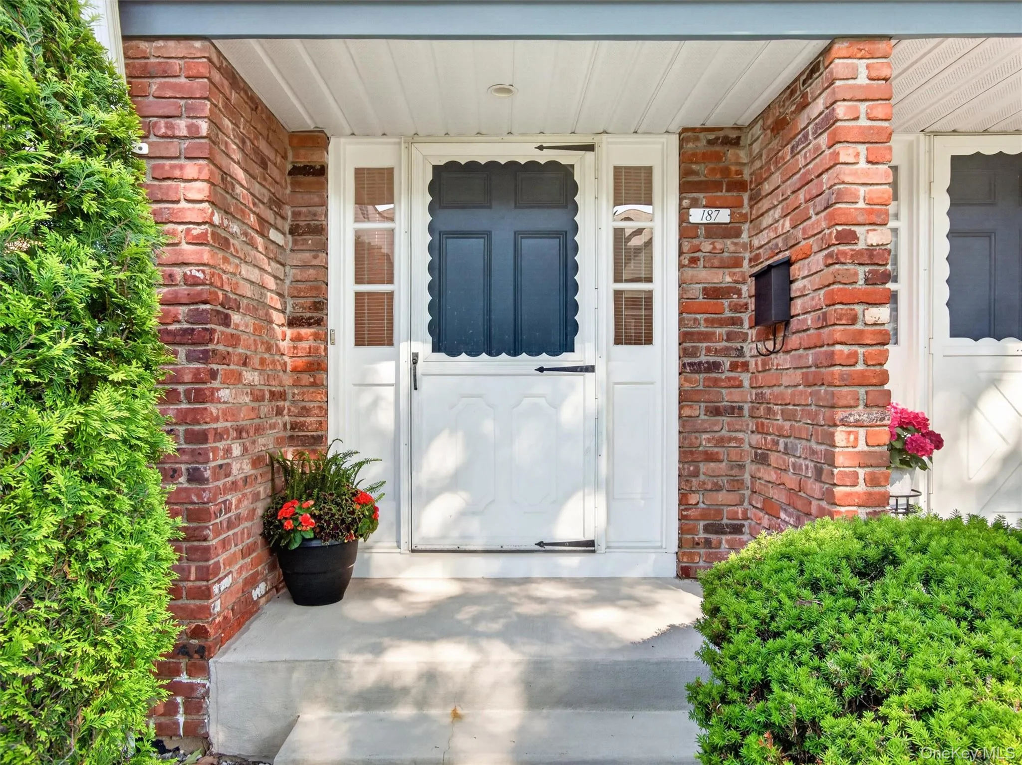 Welcoming covered front entrance with attractive brick exterior and mature landscaping. Welcoming covered front entrance with attractive brick exterior and mature landscaping.