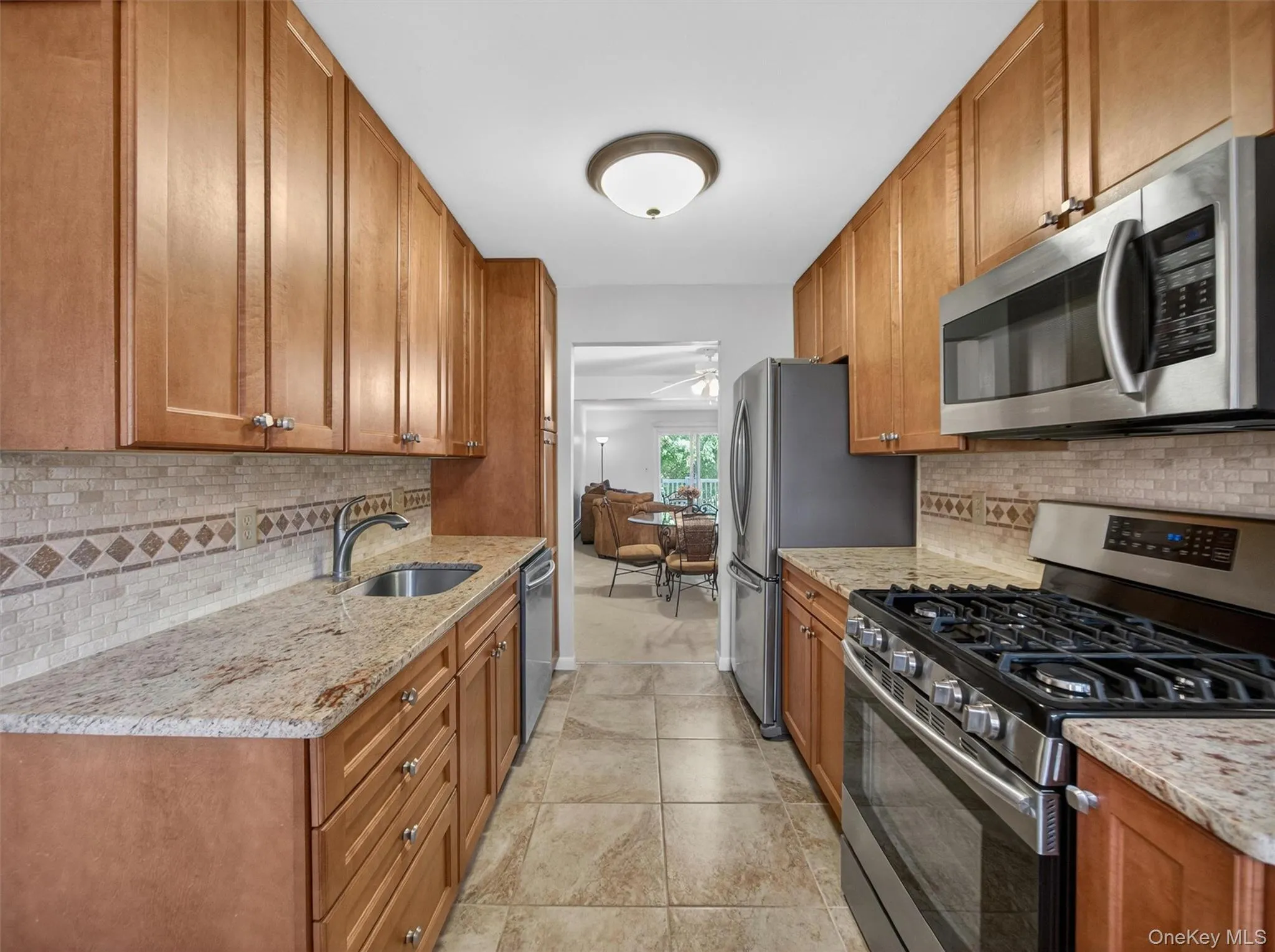 Galley-style kitchen offering generous storage, ample workspace, and easy access to the home's main living areas. Galley-style kitchen offering generous storage, ample workspace, and easy access to the home's main living areas.