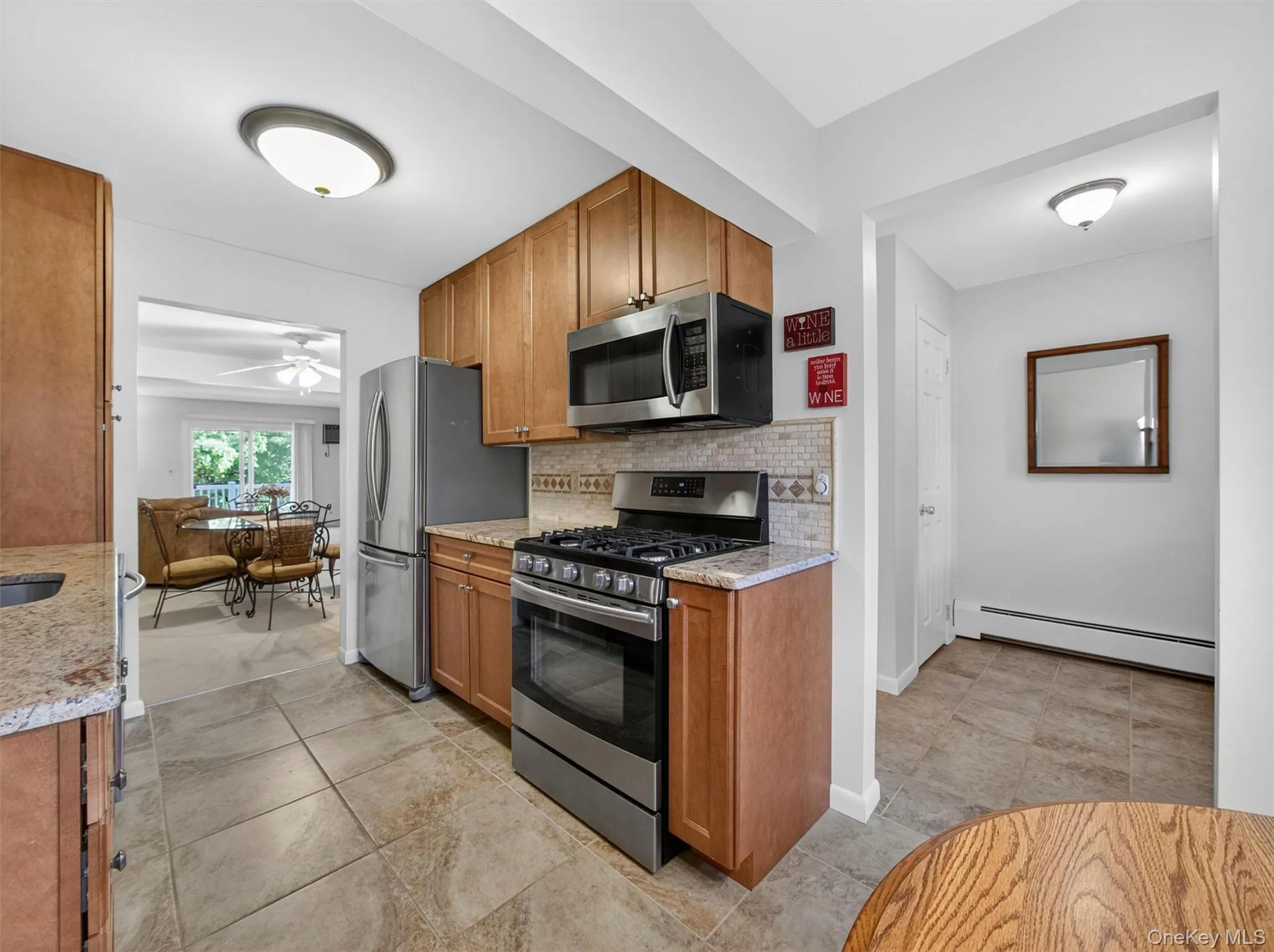 Well-designed kitchen featuring stainless steel appliances, abundant cabinetry, and a seamless flow to the dining and living spaces. Well-designed kitchen featuring stainless steel appliances, abundant cabinetry, and a seamless flow to the dining and living spaces.