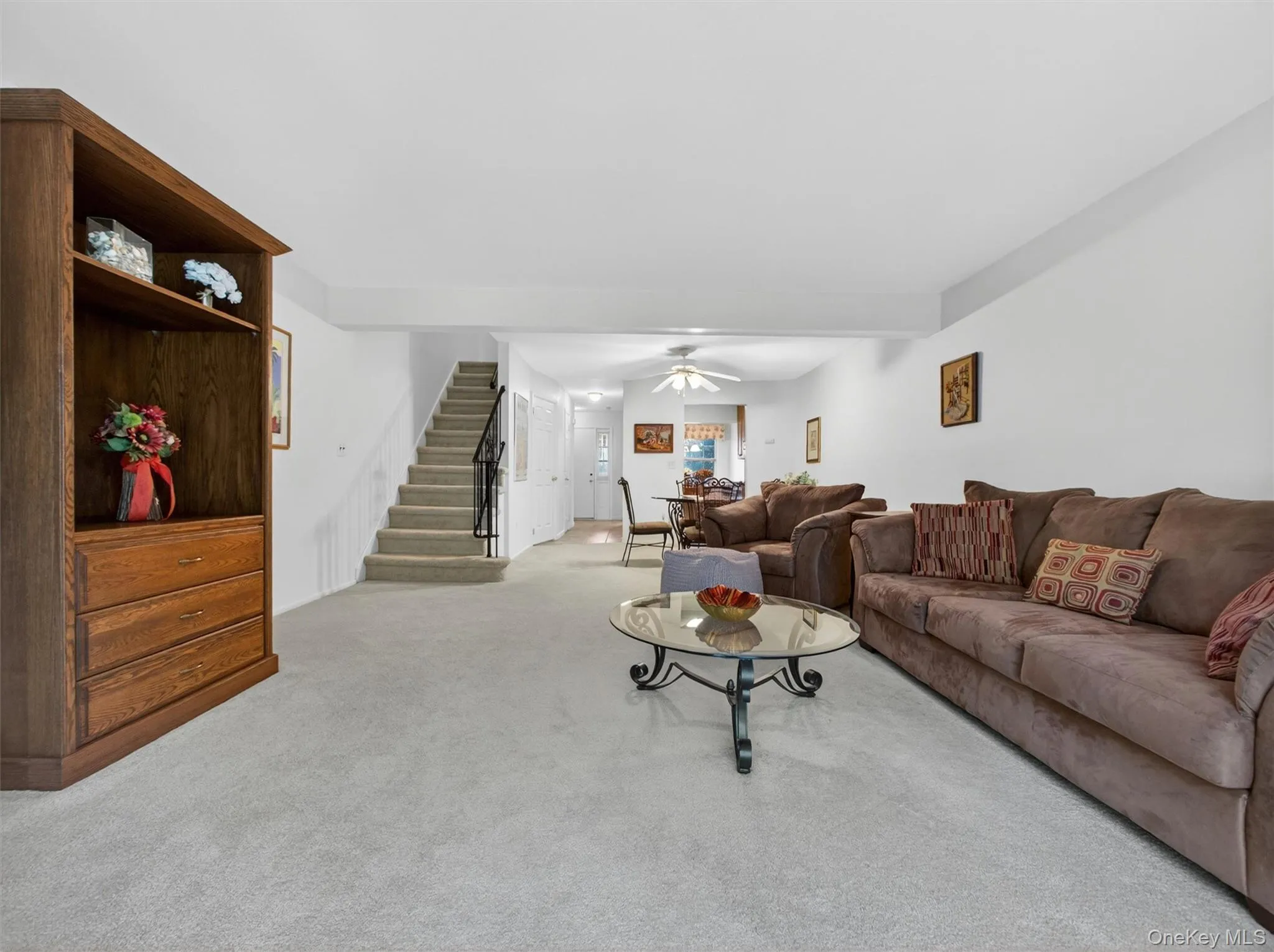Spacious living room with an open layout and seamless flow to the dining area and upper level. Spacious living room with an open layout and seamless flow to the dining area and upper level.