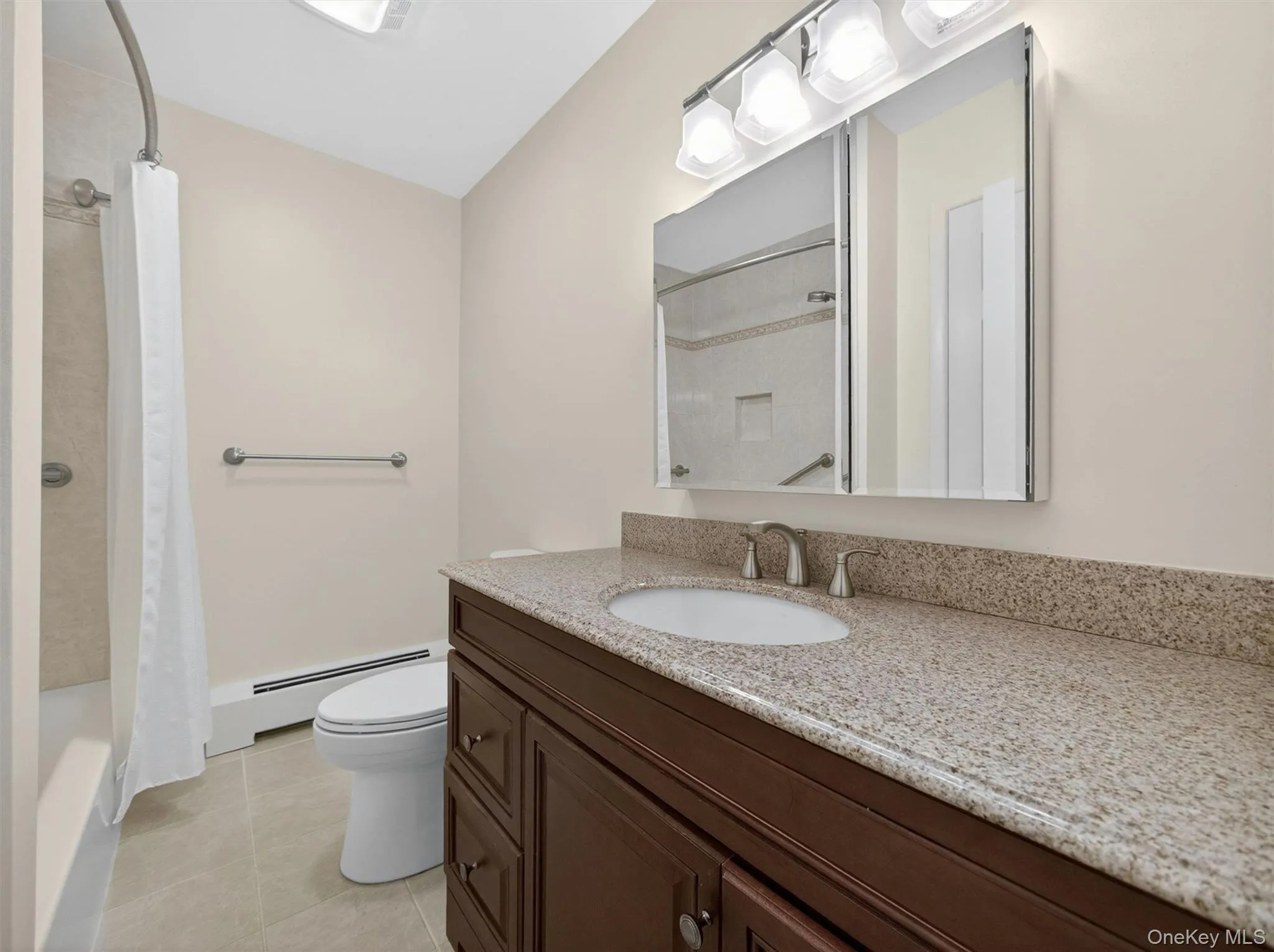 Full hall bathroom featuring an oversized vanity with ample storage and counter space. Full hall bathroom featuring an oversized vanity with ample storage and counter space.
