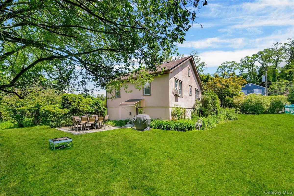 Expansive green lawn with mature trees providing partial shade Expansive green lawn with mature trees providing partial shade
