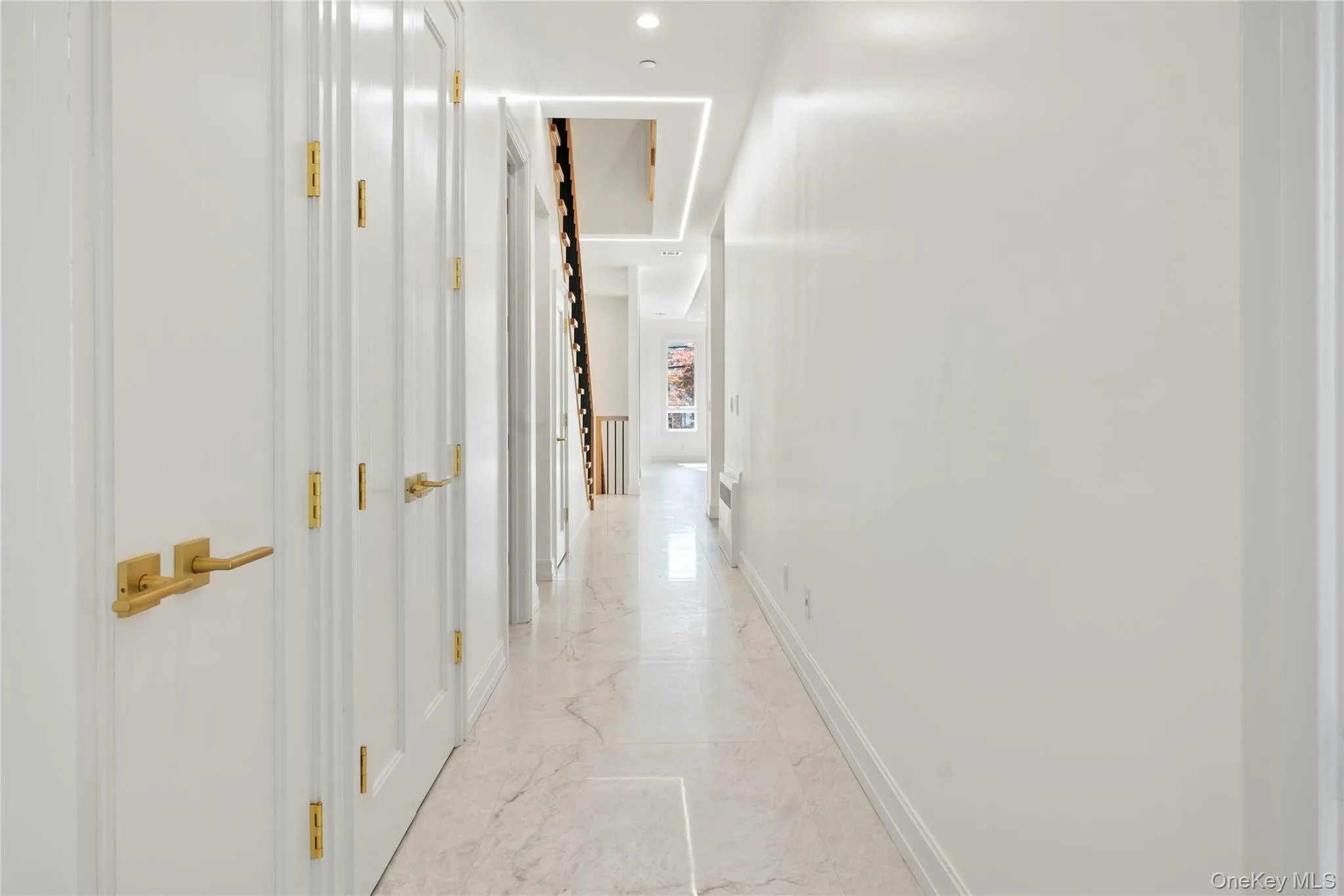 Corridor with recessed lighting and light marble finish flooring Corridor with recessed lighting and light marble finish flooring