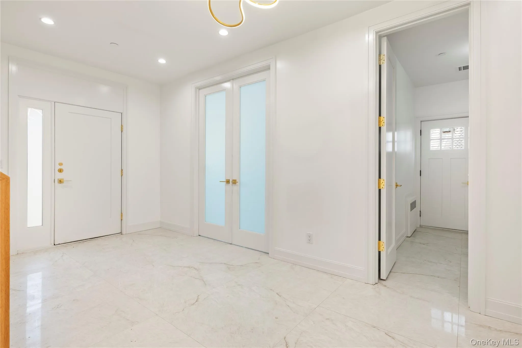 Foyer entrance with french doors and recessed lighting Foyer entrance with french doors and recessed lighting