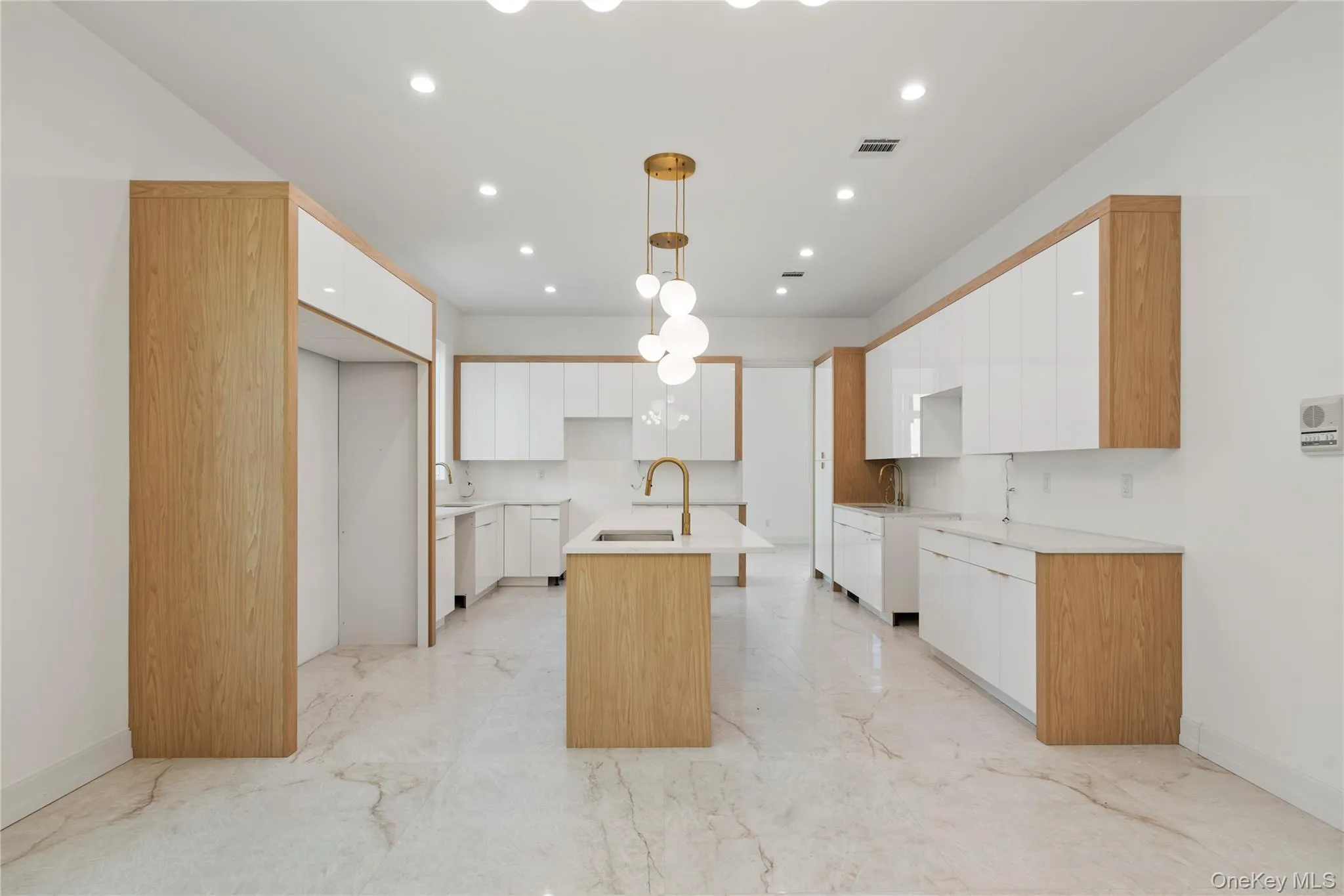 Kitchen featuring white cabinetry, a center island with sink, hanging light fixtures, modern cabinets, and recessed lighting Kitchen featuring white cabinetry, a center island with sink, hanging light fixtures, modern cabinets, and recessed lighting