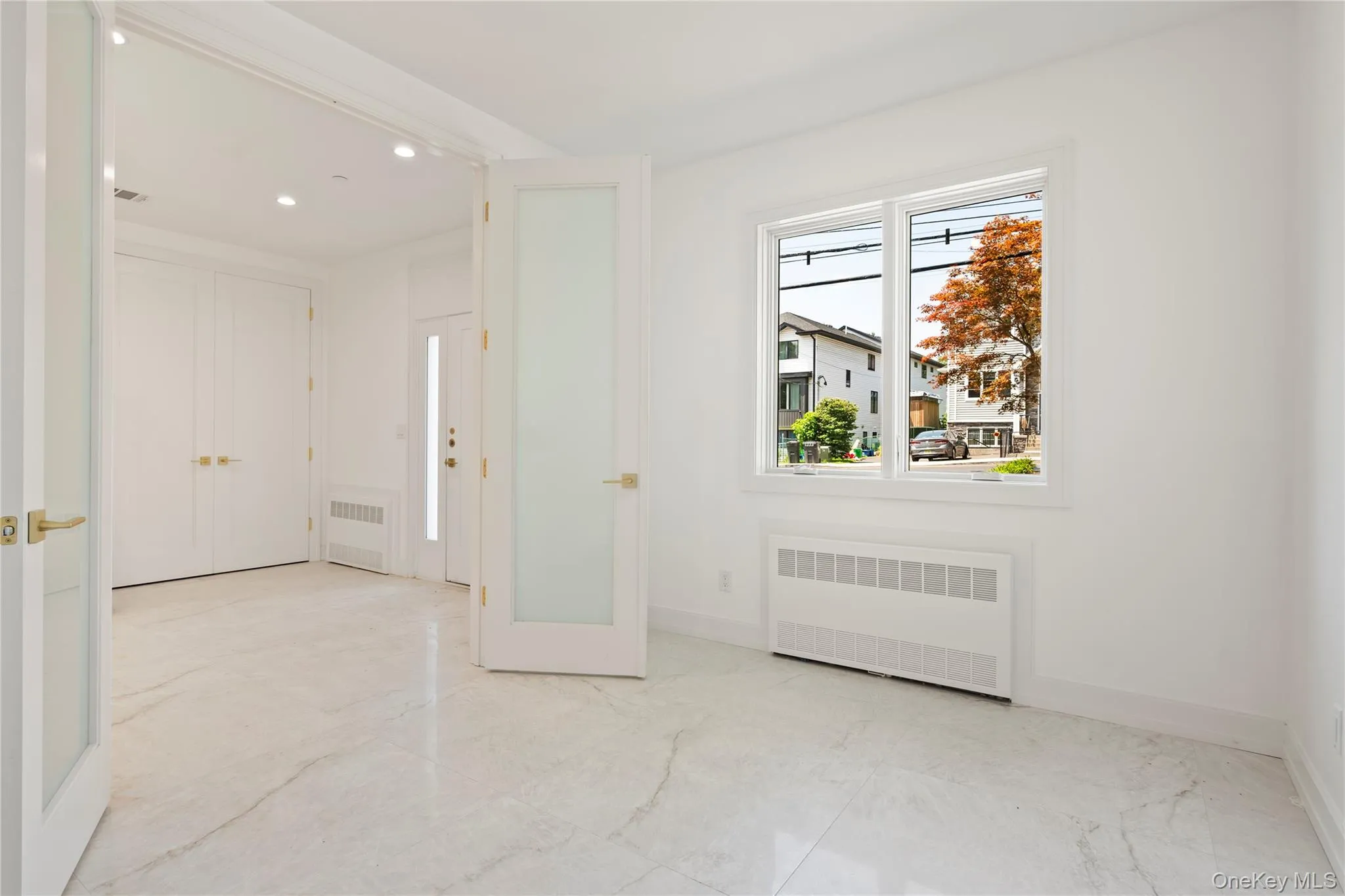 Foyer entrance with radiator and recessed lighting Foyer entrance with radiator and recessed lighting