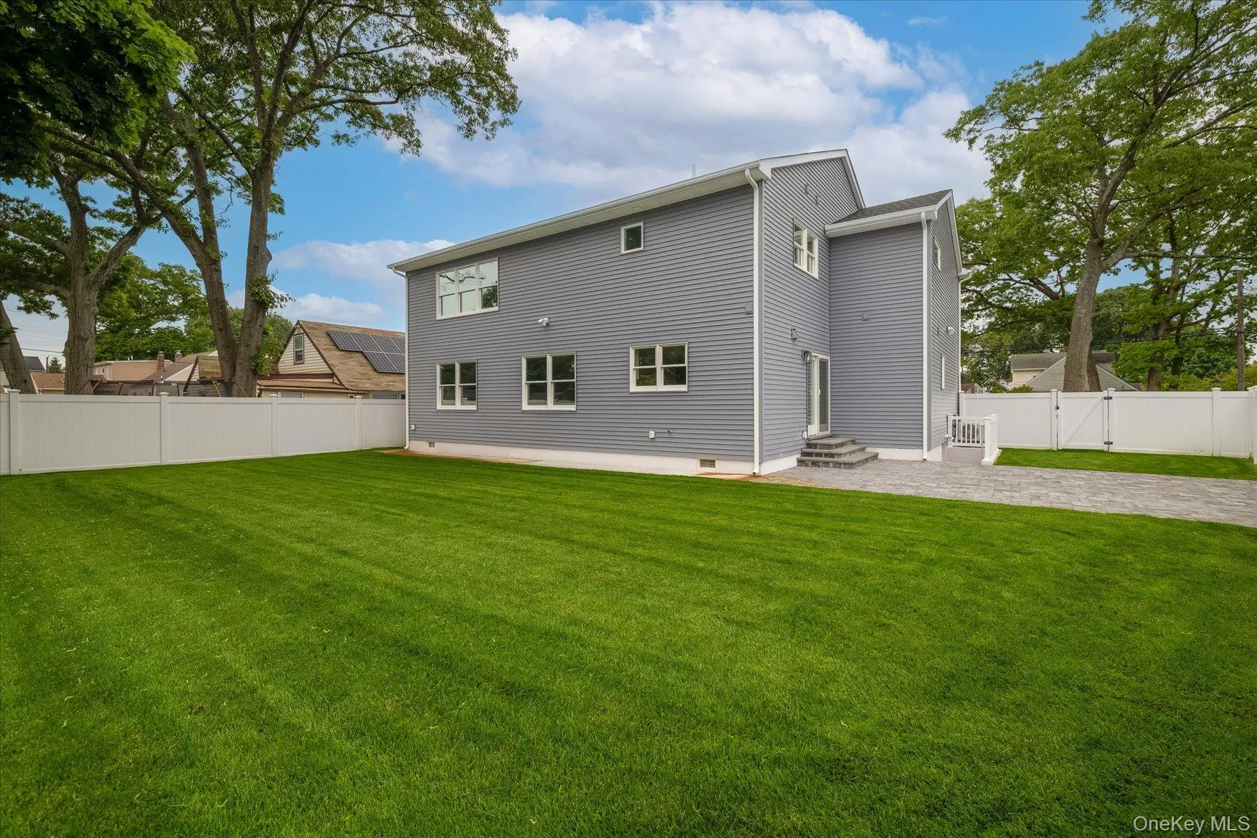 The property features a spacious, fully fenced yard and lush, manicured gardens The property features a spacious, fully fenced yard and lush, manicured gardens