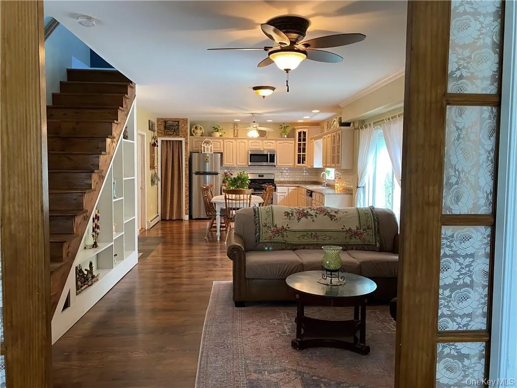 Living room with beautiful wood floors and ceiling fan Living room with beautiful wood floors and ceiling fan