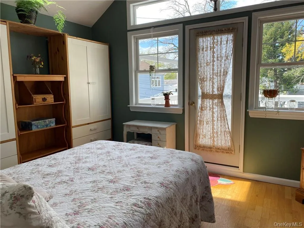 Second floor Primary Bedroom with door out to deck and beautiful water views Second floor Primary Bedroom with door out to deck and beautiful water views
