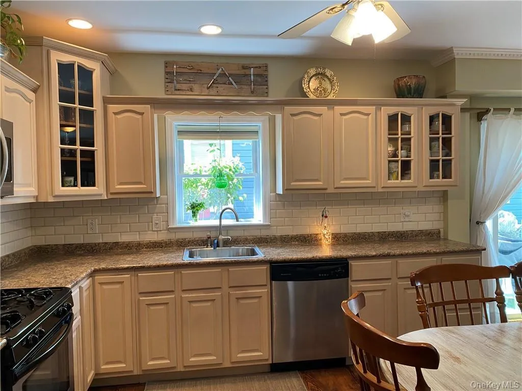 Eat in Kitchen with recessed lighting and decorative cabinets Eat in Kitchen with recessed lighting and decorative cabinets