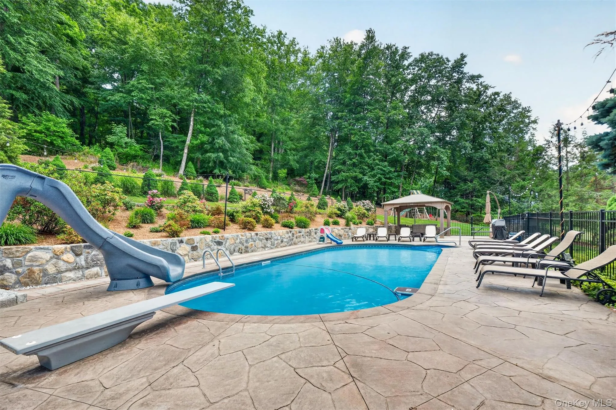 Incredible, deep, salt-water, heated pool surrounded by a stamped-concrete patio. Incredible, deep, salt-water, heated pool surrounded by a stamped-concrete patio.