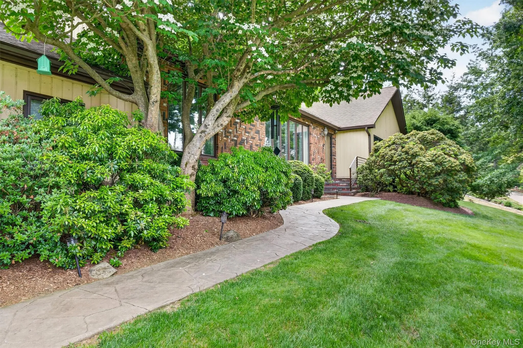 Beautiful curb appeal, with mature plantings and a stamped concrete front walkway. Beautiful curb appeal, with mature plantings and a stamped concrete front walkway.