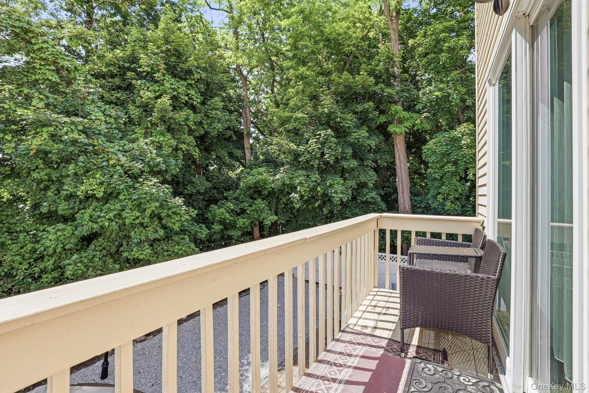 Private balcony featuring an exterior sliding glass door and durable siding Private balcony featuring an exterior sliding glass door and durable siding