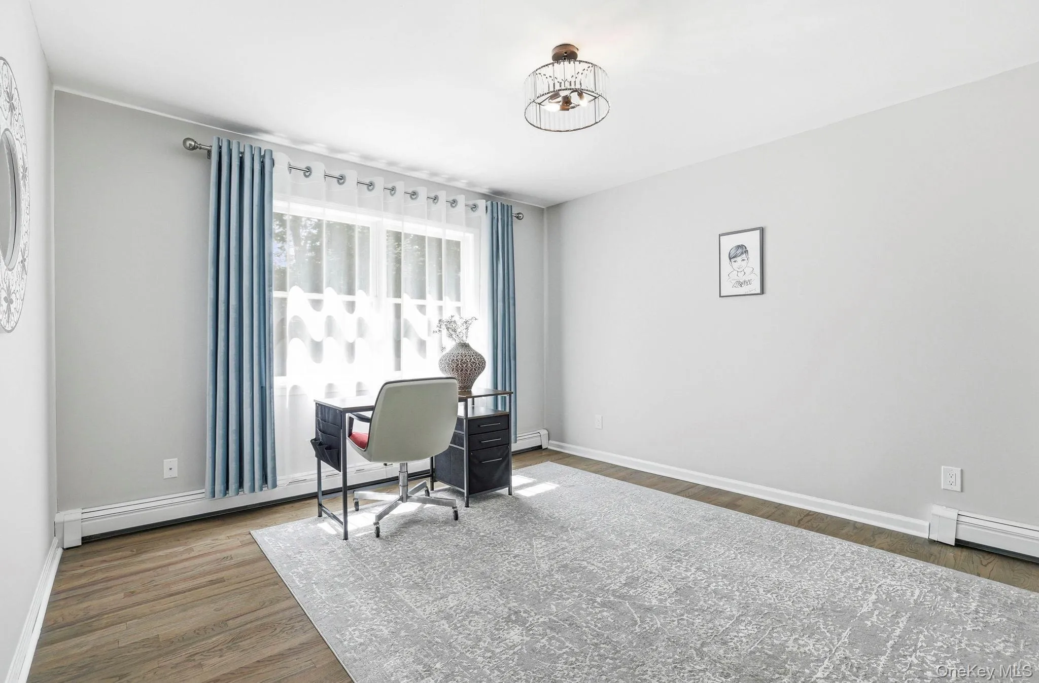 Bright interior space featuring wood-finish flooring and a decorative semi-flush mount ceiling fixture Bright interior space featuring wood-finish flooring and a decorative semi-flush mount ceiling fixture