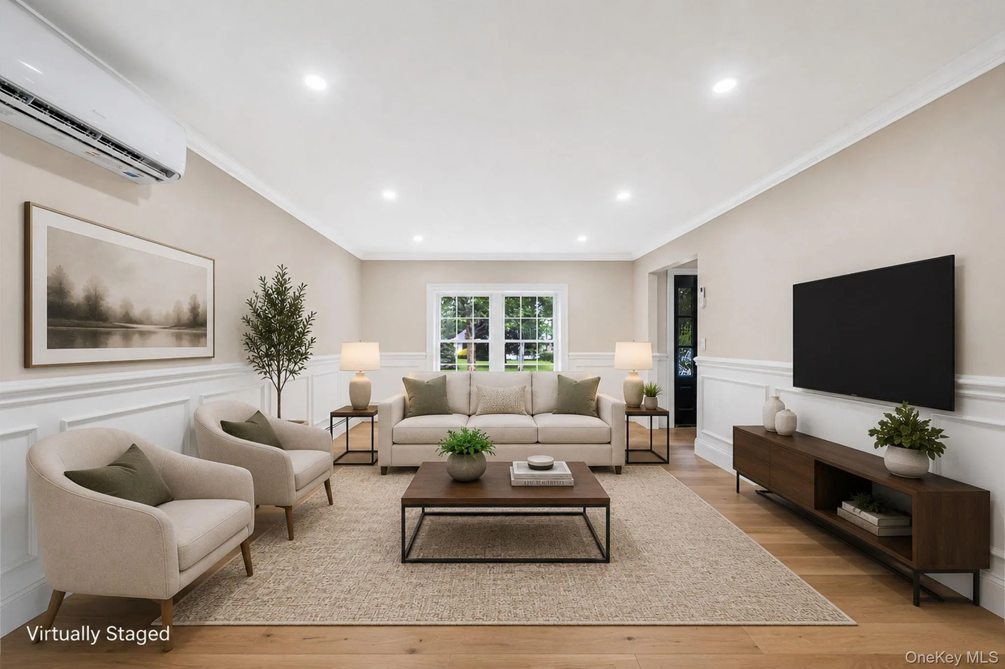 Spacious living area featuring light wood-finish flooring, recessed lighting, and crown molding Spacious living area featuring light wood-finish flooring, recessed lighting, and crown molding