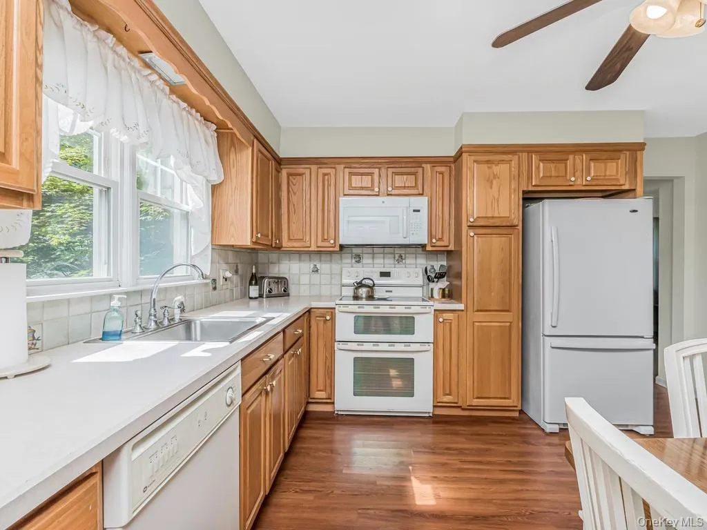 Large, bright eat in kitchen. Cabinets have sliders for easy access Large, bright eat in kitchen. Cabinets have sliders for easy access