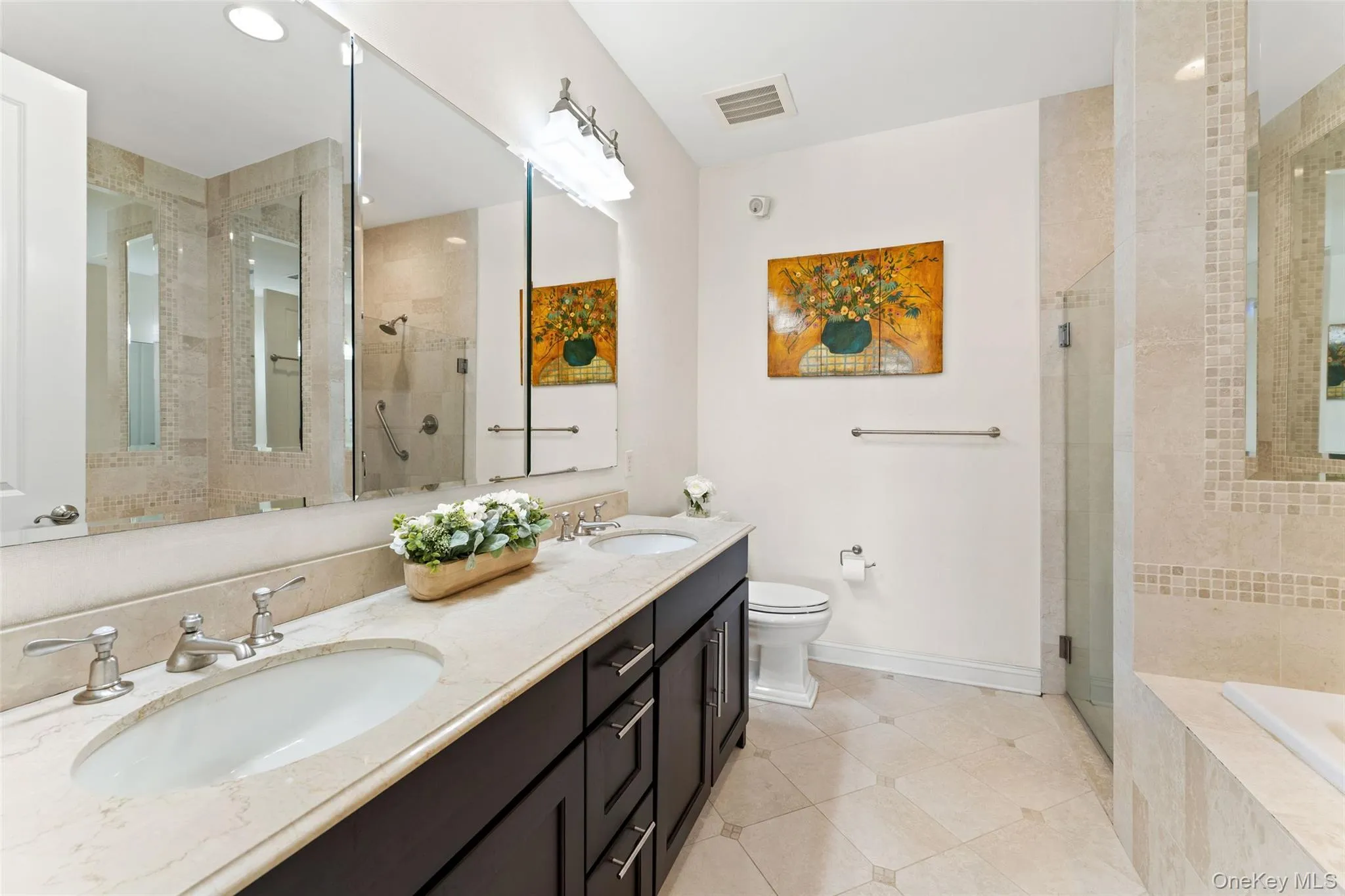 Primary bathroom with double vanity, stall shower and soaking tub. Primary bathroom with double vanity, stall shower and soaking tub.
