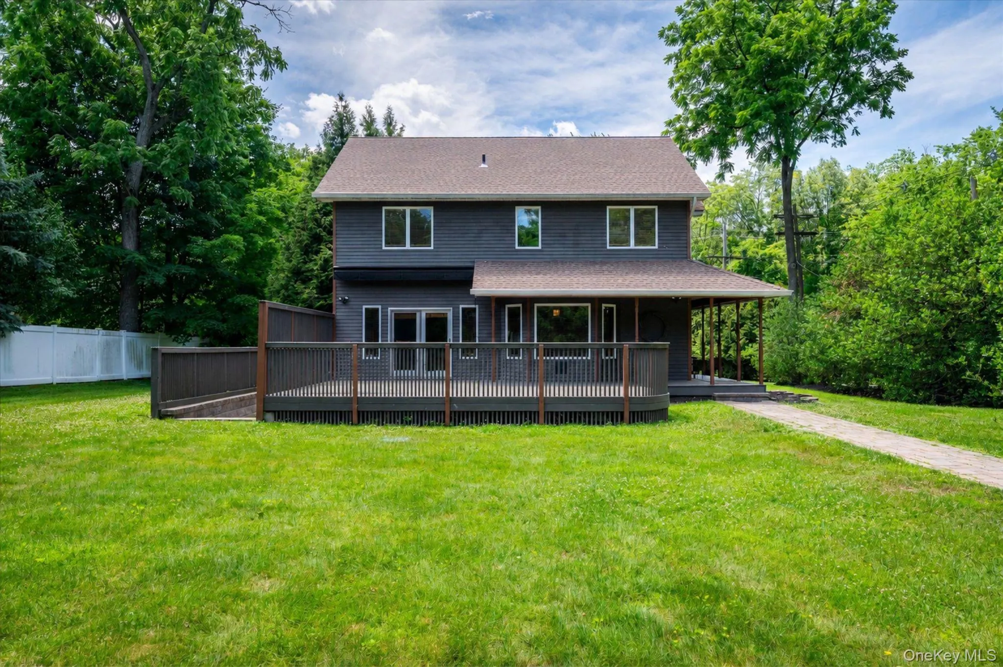 Back of home with Deck and Lawn Back of home with Deck and Lawn
