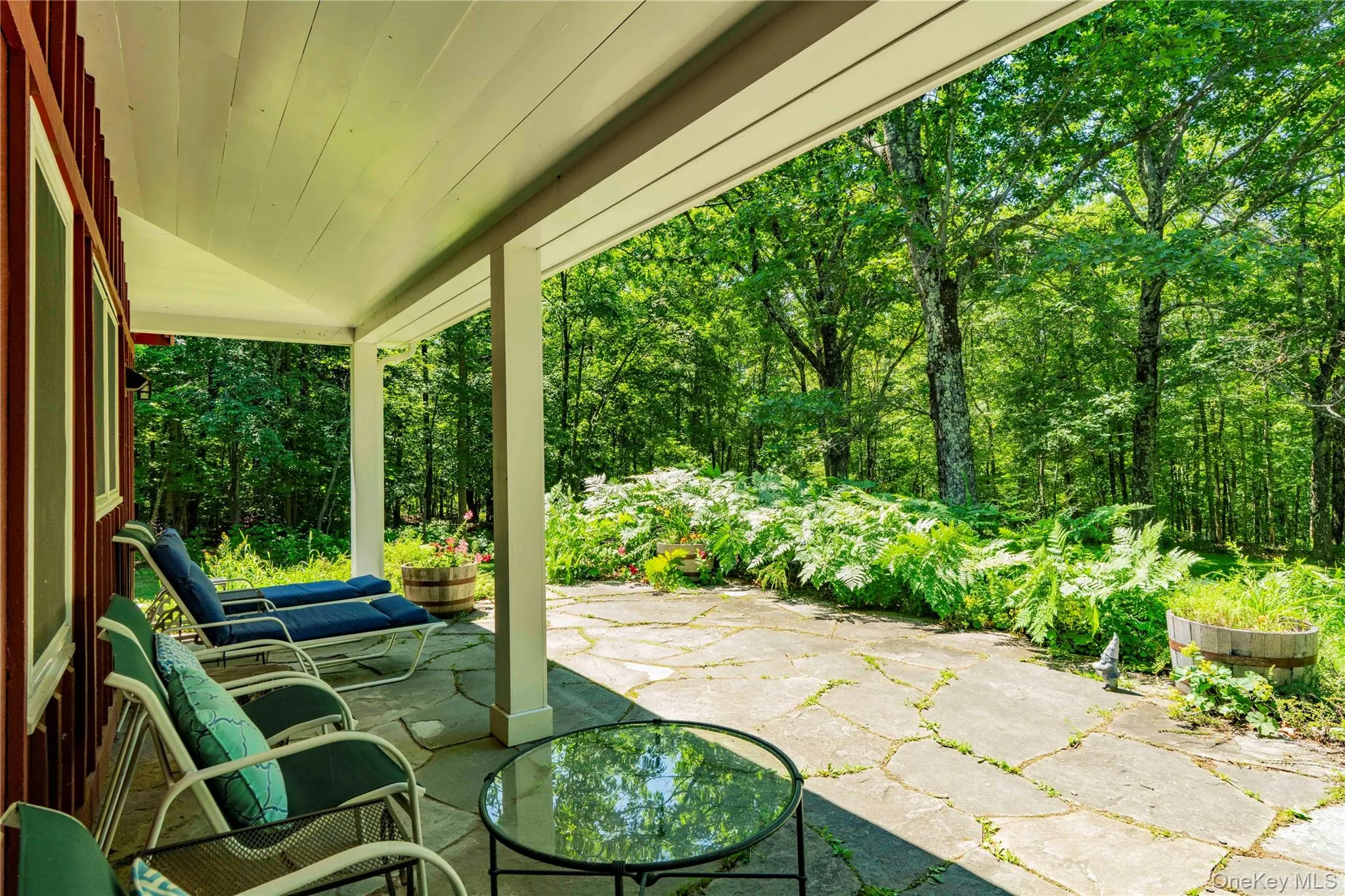 View from Covered Porch Sitting Area Out to Patio & Gardens View from Covered Porch Sitting Area Out to Patio & Gardens