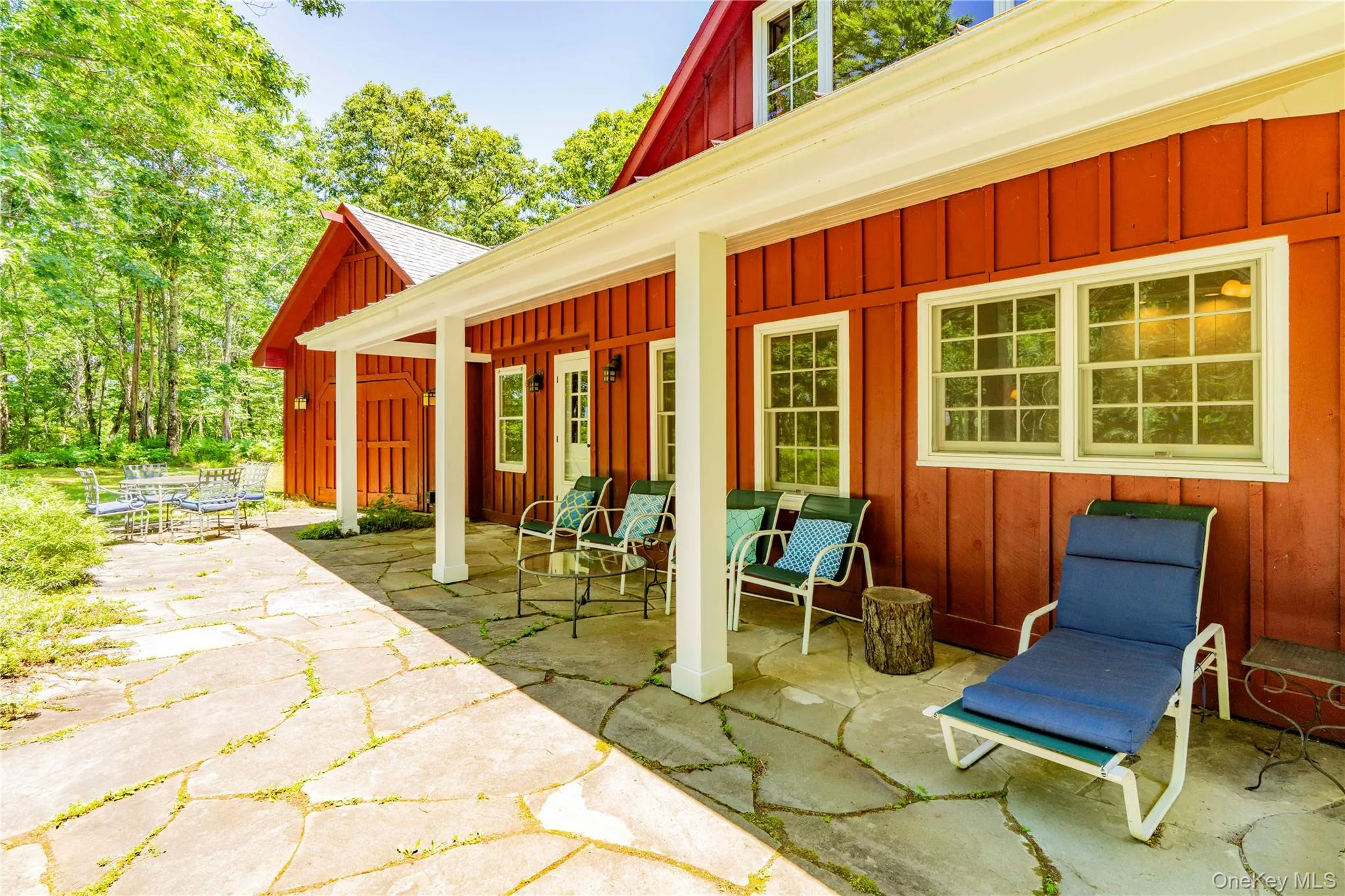 Covered Sitting Porch Opens to Large Blue Stone Patio Covered Sitting Porch Opens to Large Blue Stone Patio