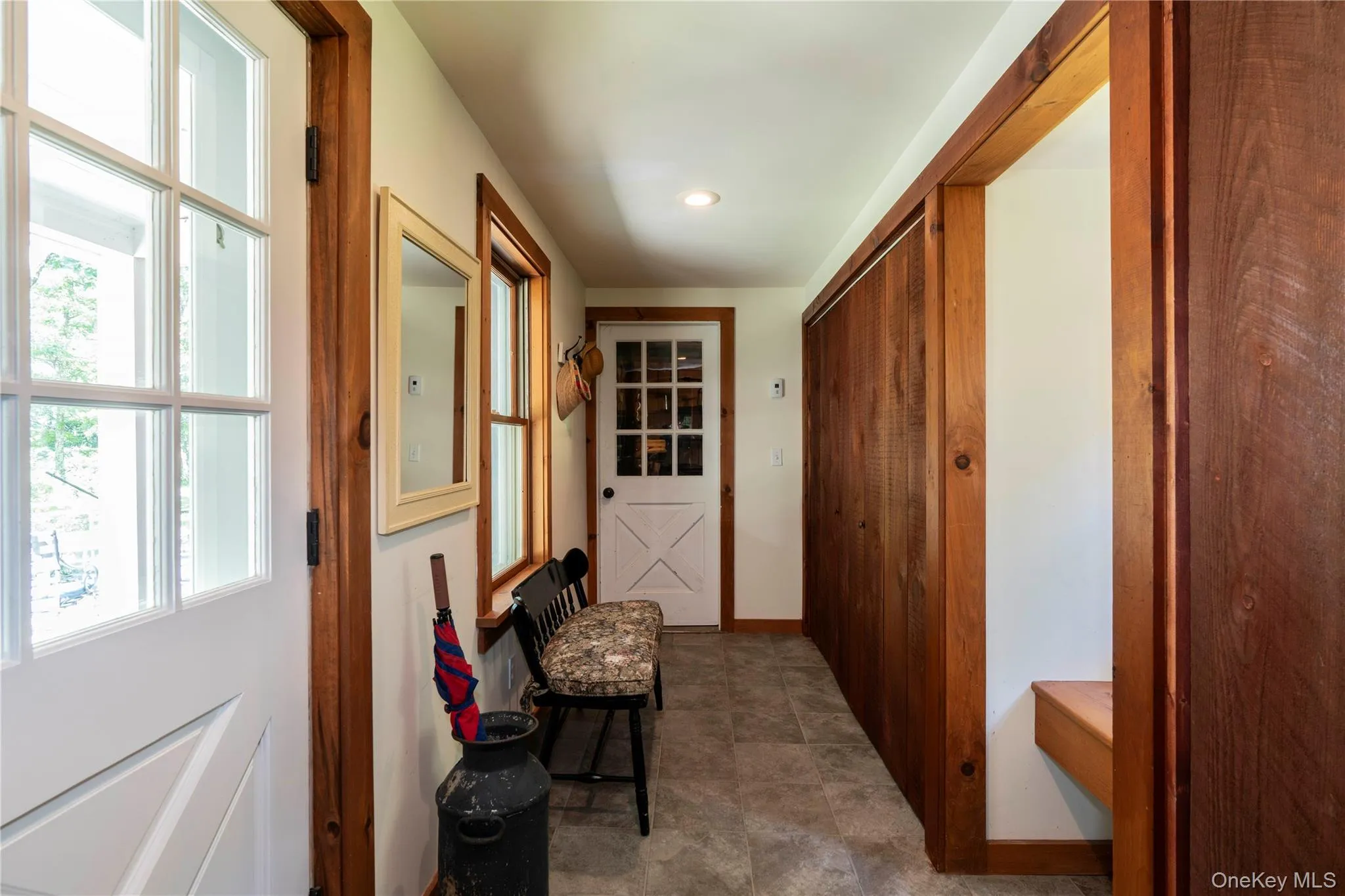 Foyer with Stone Floor, Sitting Area, Laundry & Coat Closet Foyer with Stone Floor, Sitting Area, Laundry & Coat Closet