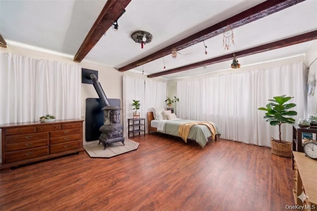 Virtually Staged: A spacious bedroom with flexible potential as a primary sleeping area. Virtually Staged: A spacious bedroom with flexible potential as a primary sleeping area.