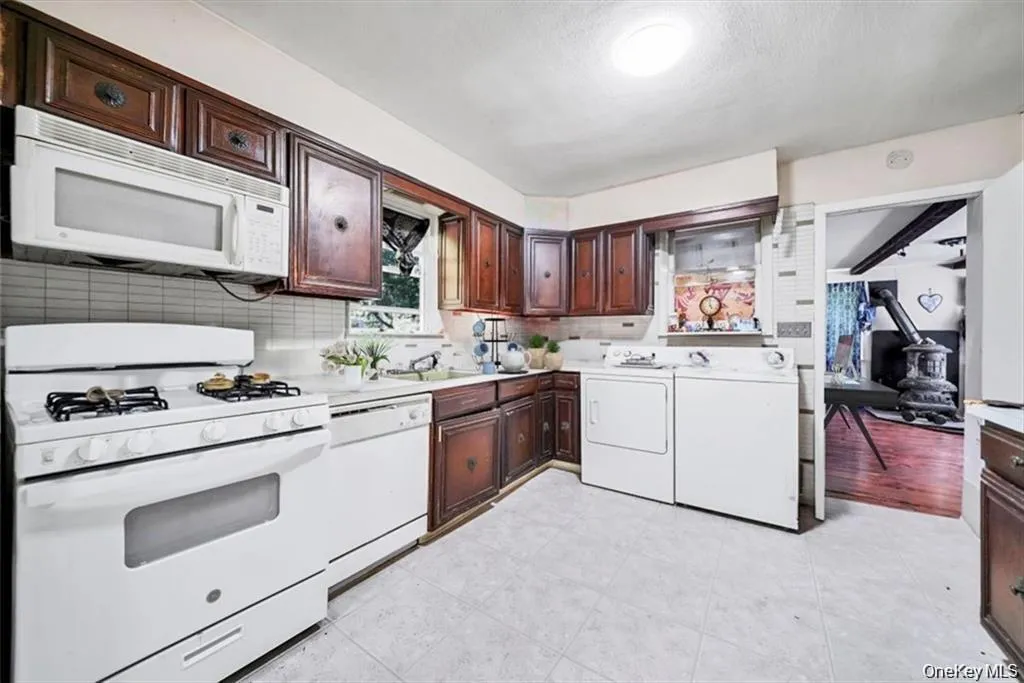 Virtually Staged: The kitchen offers a practical layout with cabinet and counter space for daily use. Virtually Staged: The kitchen offers a practical layout with cabinet and counter space for daily use.