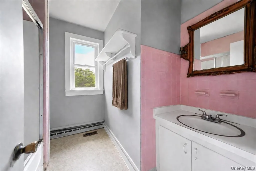 A full bathroom offering everyday functionality. While the space may benefit from future updates, it provides essential convenience for the home. A full bathroom offering everyday functionality. While the space may benefit from future updates, it provides essential convenience for the home.