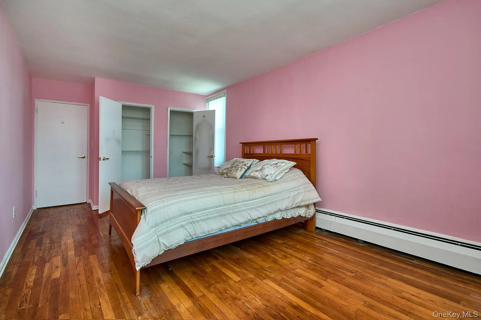 Bedroom with closet doors opened Bedroom with closet doors opened
