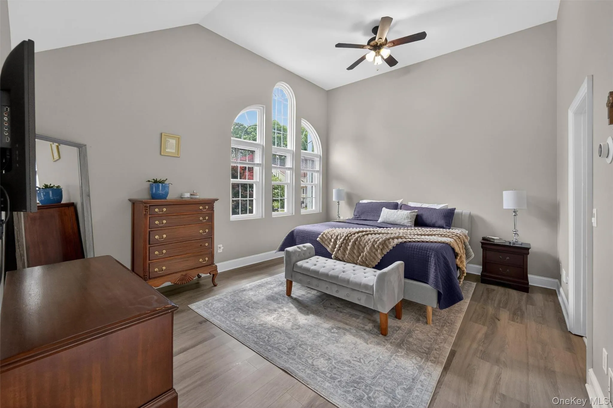 Primary Bedroom features high ceiling, ceiling fan and large window Primary Bedroom features high ceiling, ceiling fan and large window