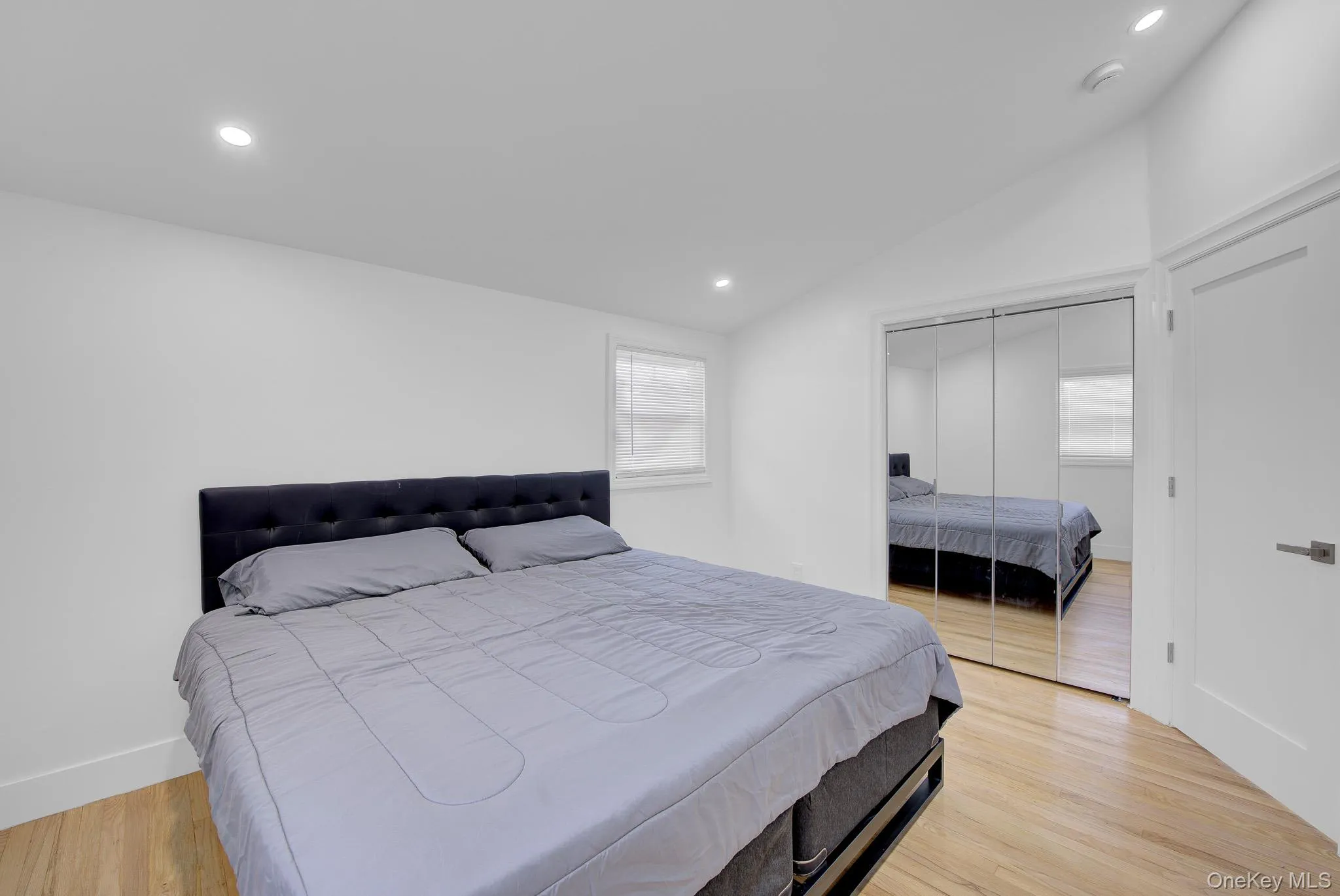 Light wood-finish flooring complements the bright white walls and recessed lighting Light wood-finish flooring complements the bright white walls and recessed lighting