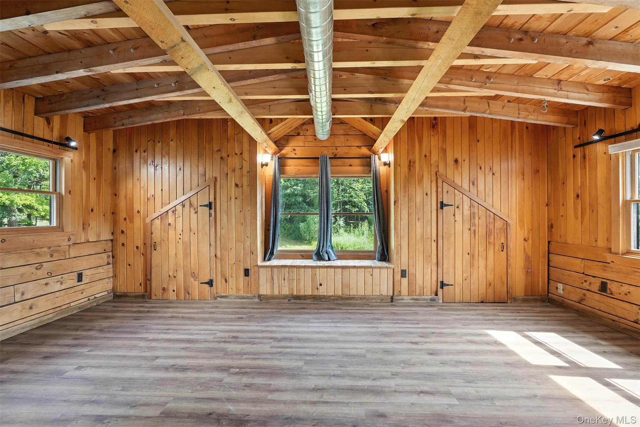 Spare room with wooden ceiling, wood finished floors, and wood walls Spare room with wooden ceiling, wood finished floors, and wood walls