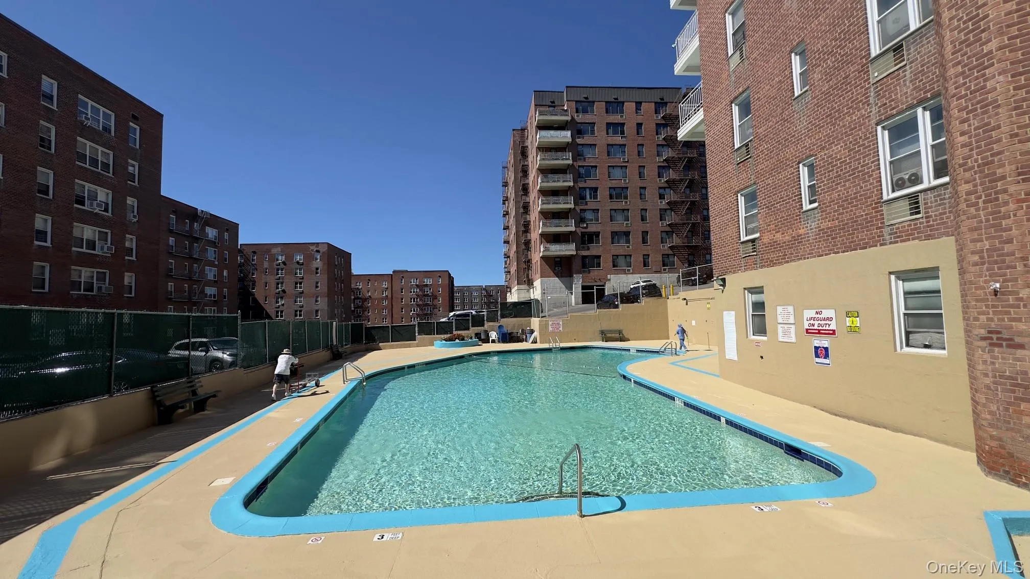 Outdoor swimming pool featuring a curved design and dressing room/toilet Outdoor swimming pool featuring a curved design and dressing room/toilet
