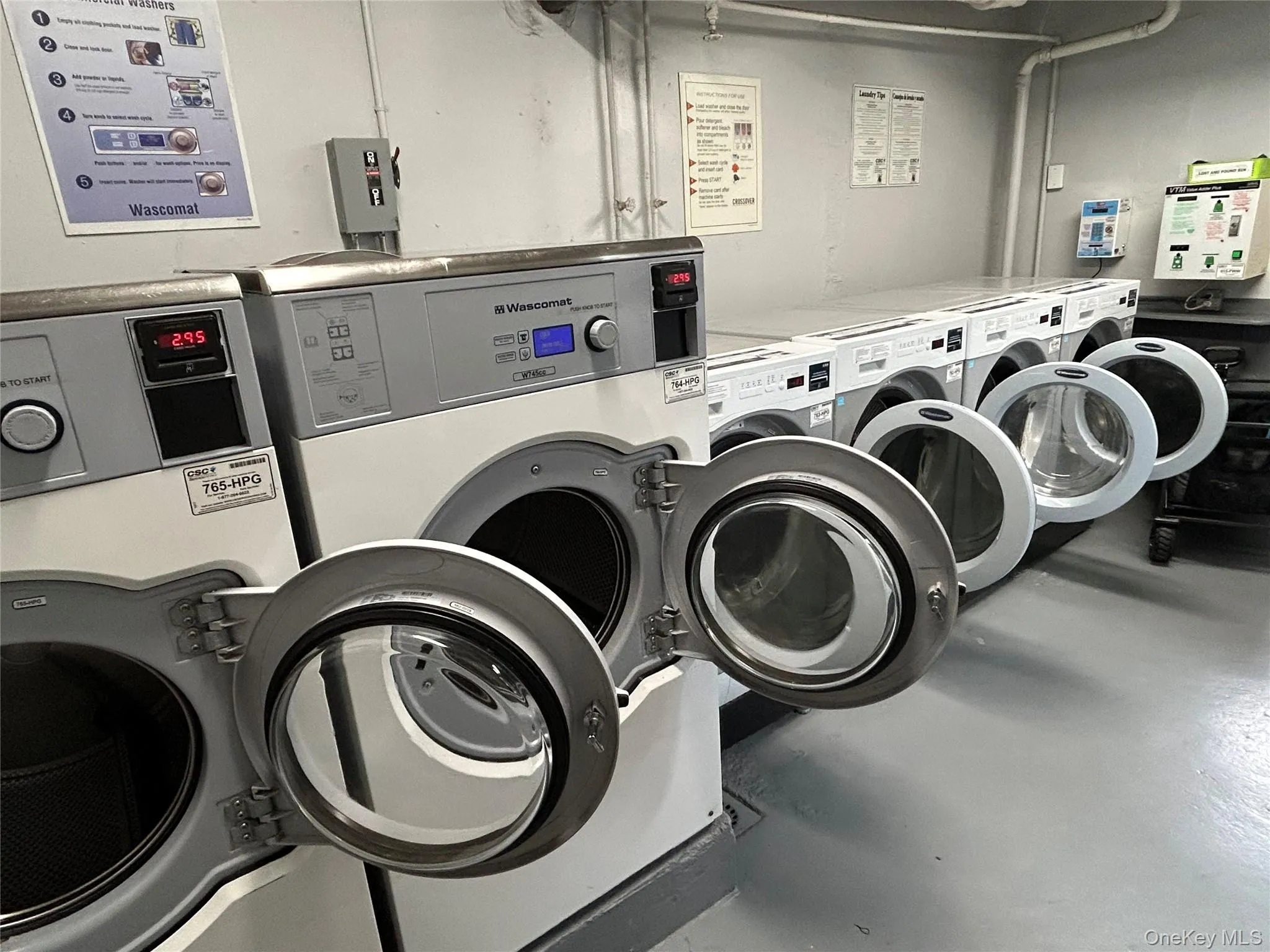 On-site laundry room featuring a row of front-loading washers and dryers On-site laundry room featuring a row of front-loading washers and dryers