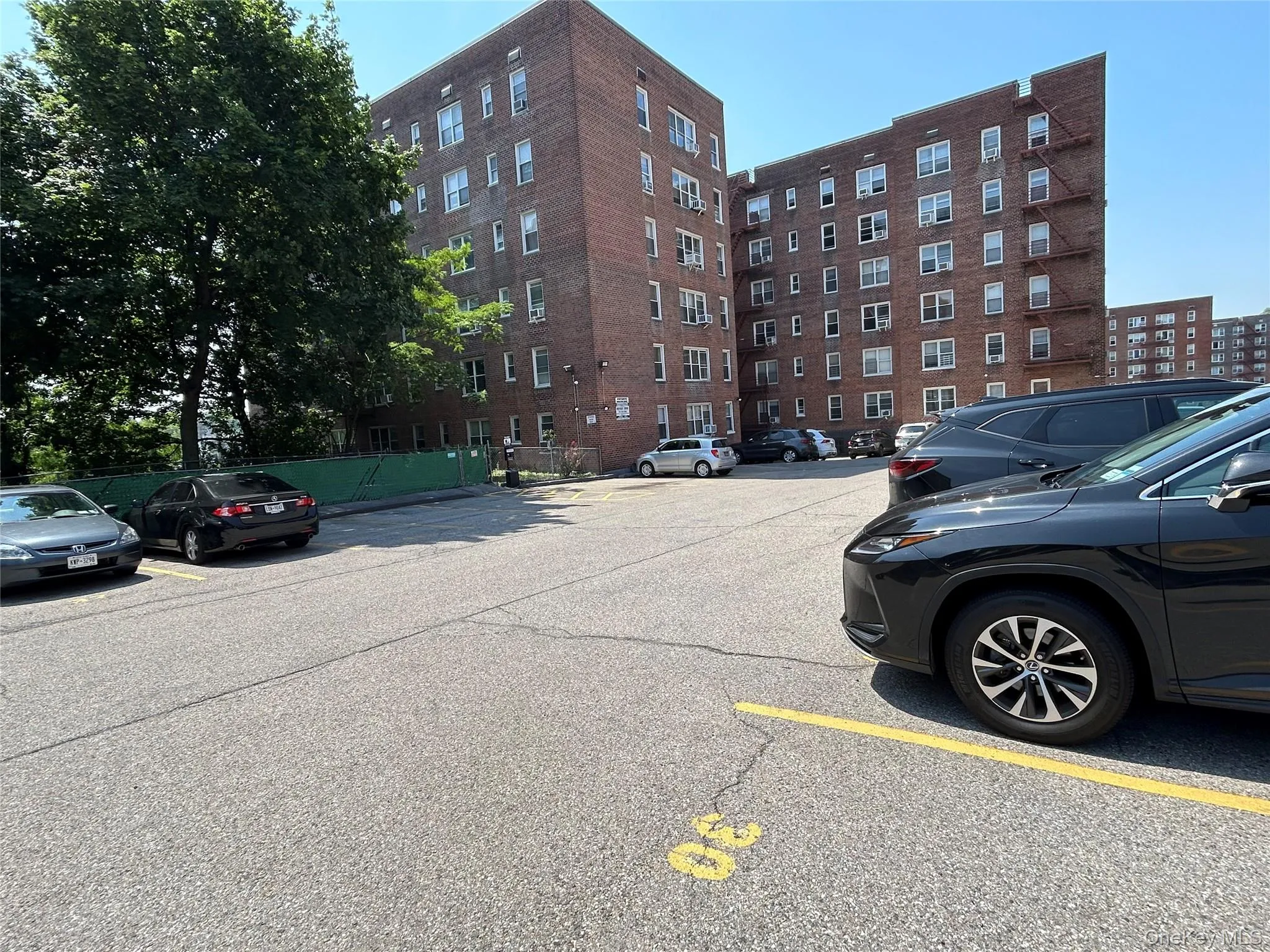 Paved parking area with marked spaces, parking space #30 comes with the unit Paved parking area with marked spaces, parking space #30 comes with the unit