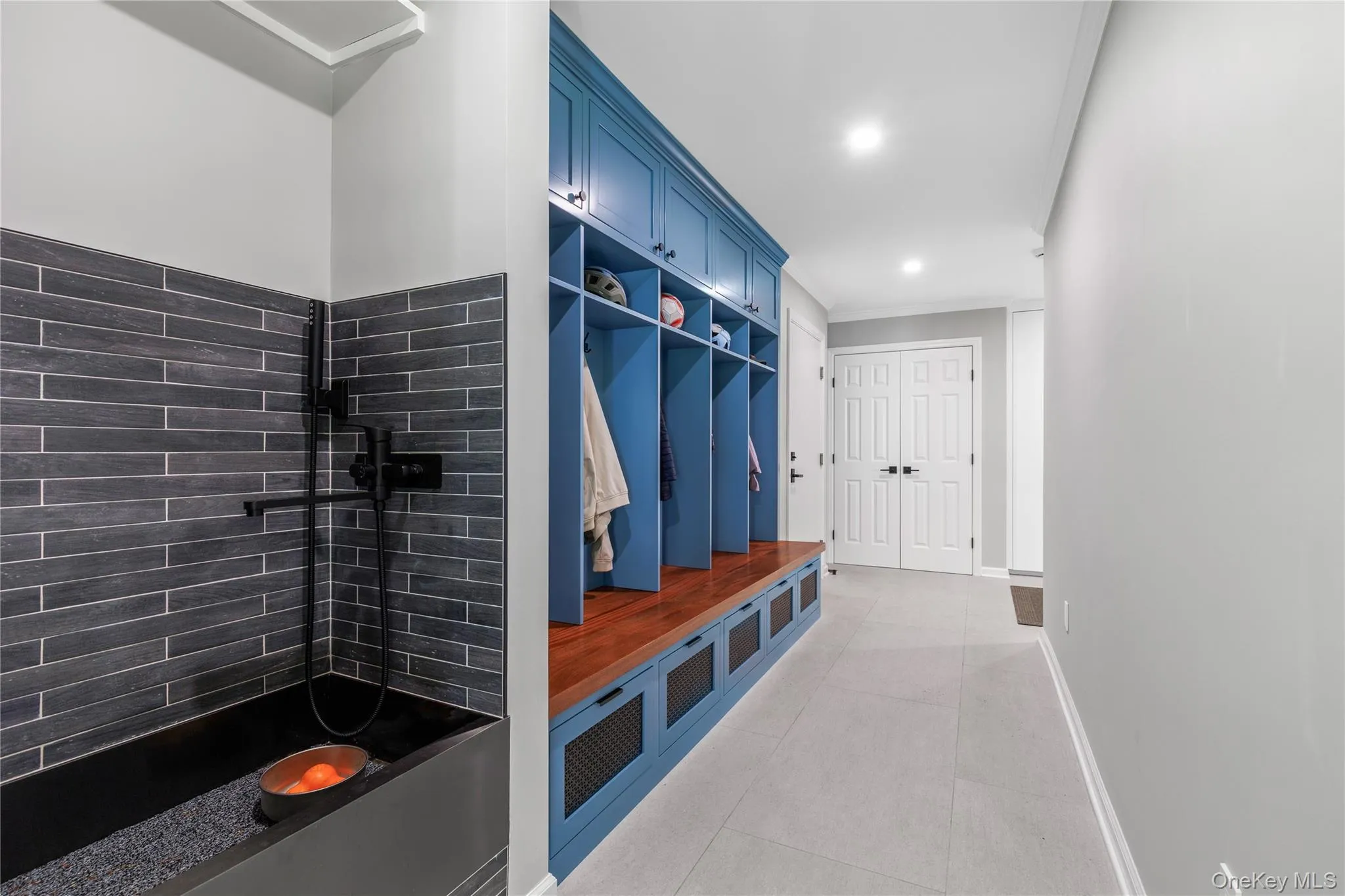 There is a cubbyhole for everyone, a shared double coat closet, and even a stylish dog wash station. There is a cubbyhole for everyone, a shared double coat closet, and even a stylish dog wash station.