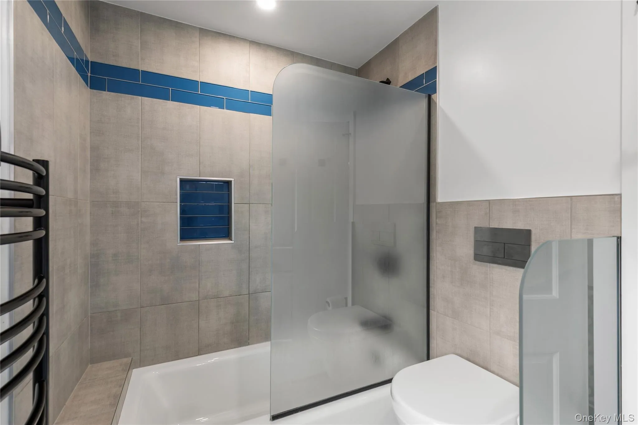The shower/tub combination, the heated towel rack and the partitioned toilet make this bathroom spacious and functional. The shower/tub combination, the heated towel rack and the partitioned toilet make this bathroom spacious and functional.