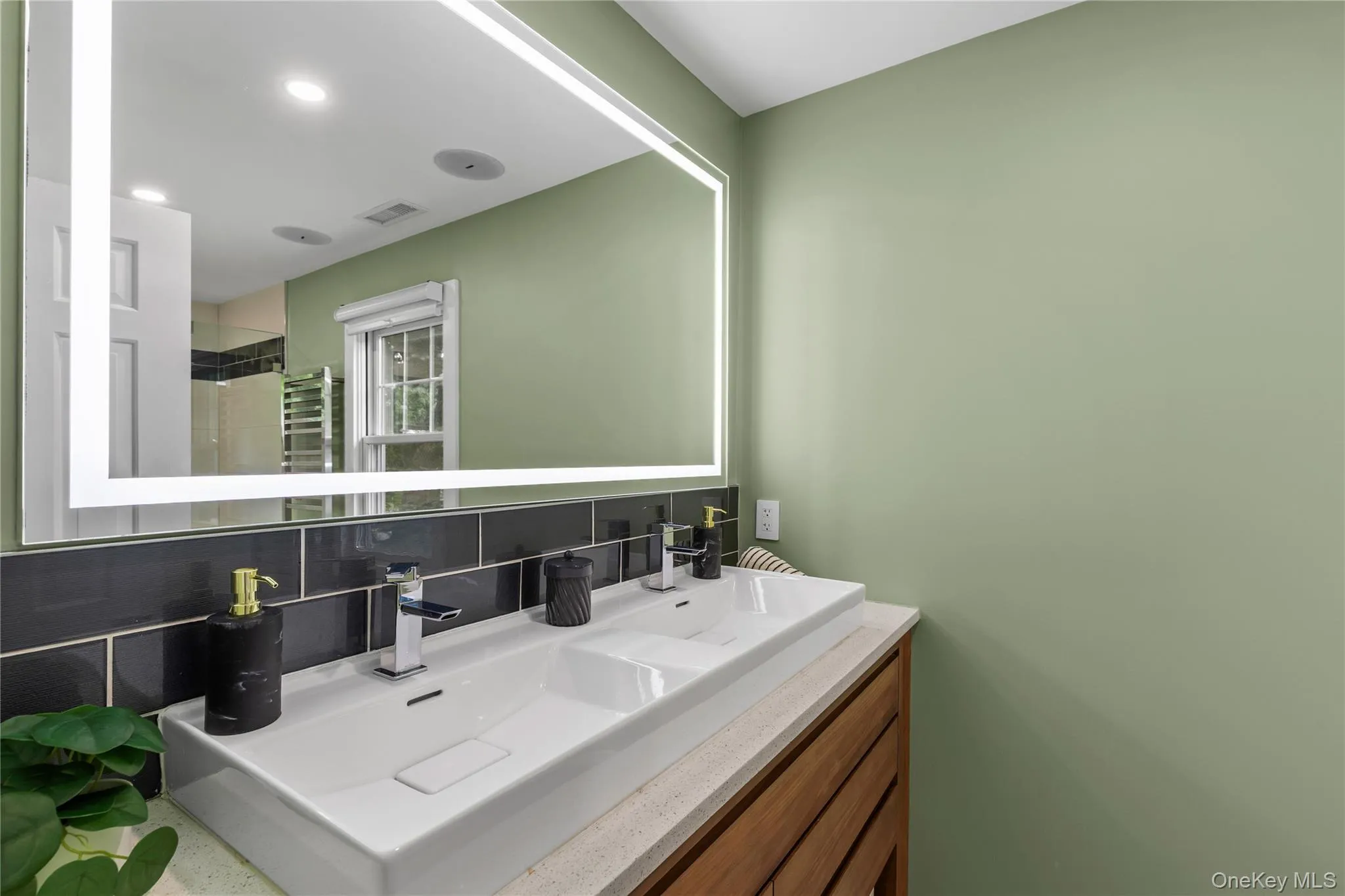 The renovated primary bathroom is generous, airy, and bright with a double vanity and storage drawers. The renovated primary bathroom is generous, airy, and bright with a double vanity and storage drawers.