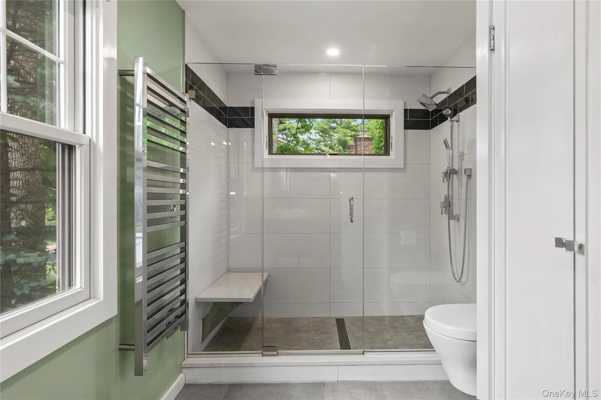 An oversized stall shower, a heated towel rack, and a full medicine closet make this space esthetic and practical. An oversized stall shower, a heated towel rack, and a full medicine closet make this space esthetic and practical.