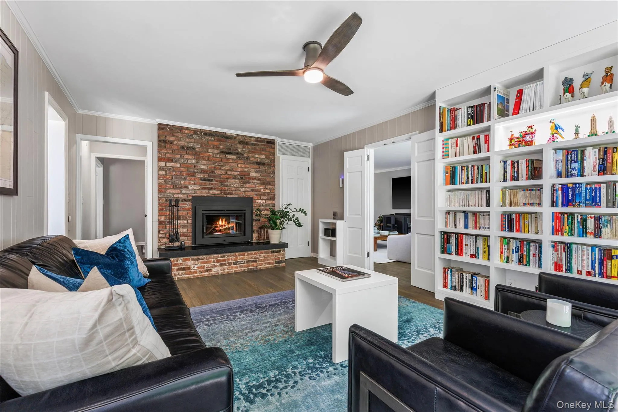 A wall of purpose built bookshelves create an ideal space for reading or playing board games by the fire. A wall of purpose built bookshelves create an ideal space for reading or playing board games by the fire.