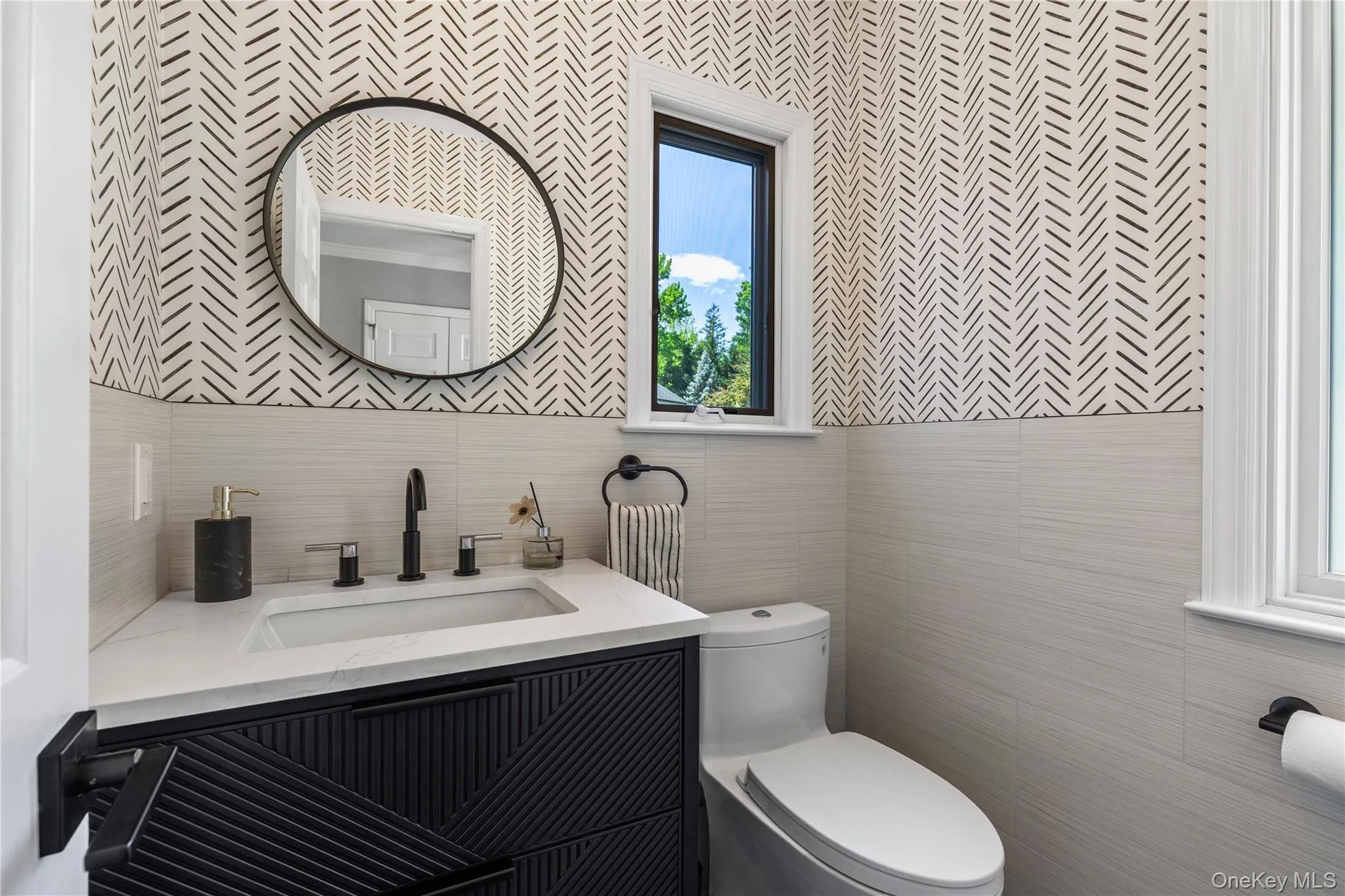 Judiciously located away from the main entertaining and living spaces, the powder room is bright and stylish. Judiciously located away from the main entertaining and living spaces, the powder room is bright and stylish.
