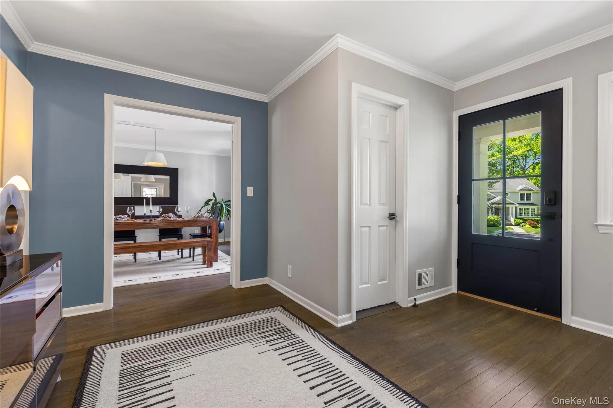 The foyer's generous proportions are augmented with wide openings to reveal the living room on one end and the dining room on the other. The foyer's generous proportions are augmented with wide openings to reveal the living room on one end and the dining room on the other.