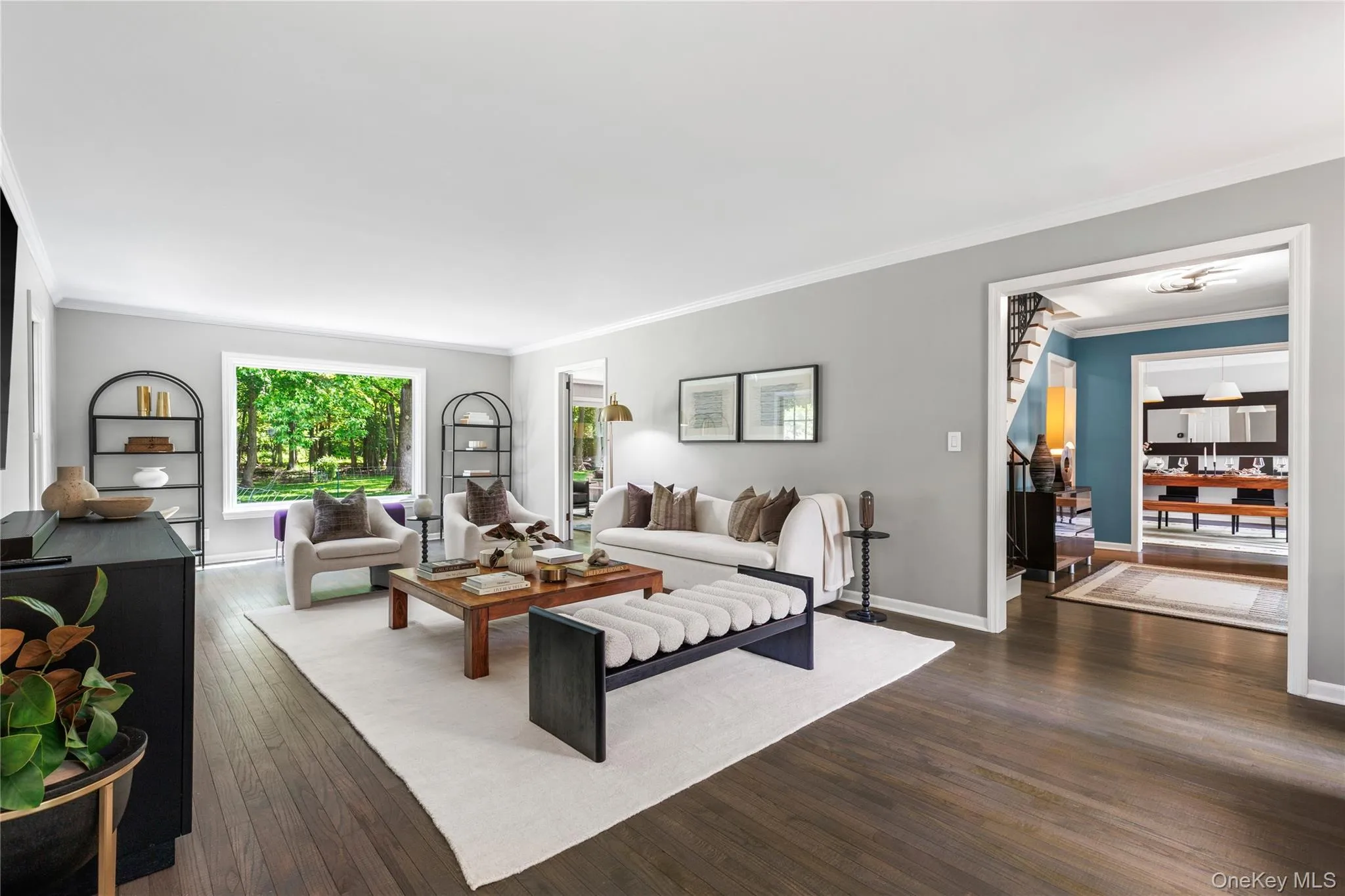 The elegant living room spans the width of the house and draws natural light from three directions. The elegant living room spans the width of the house and draws natural light from three directions.