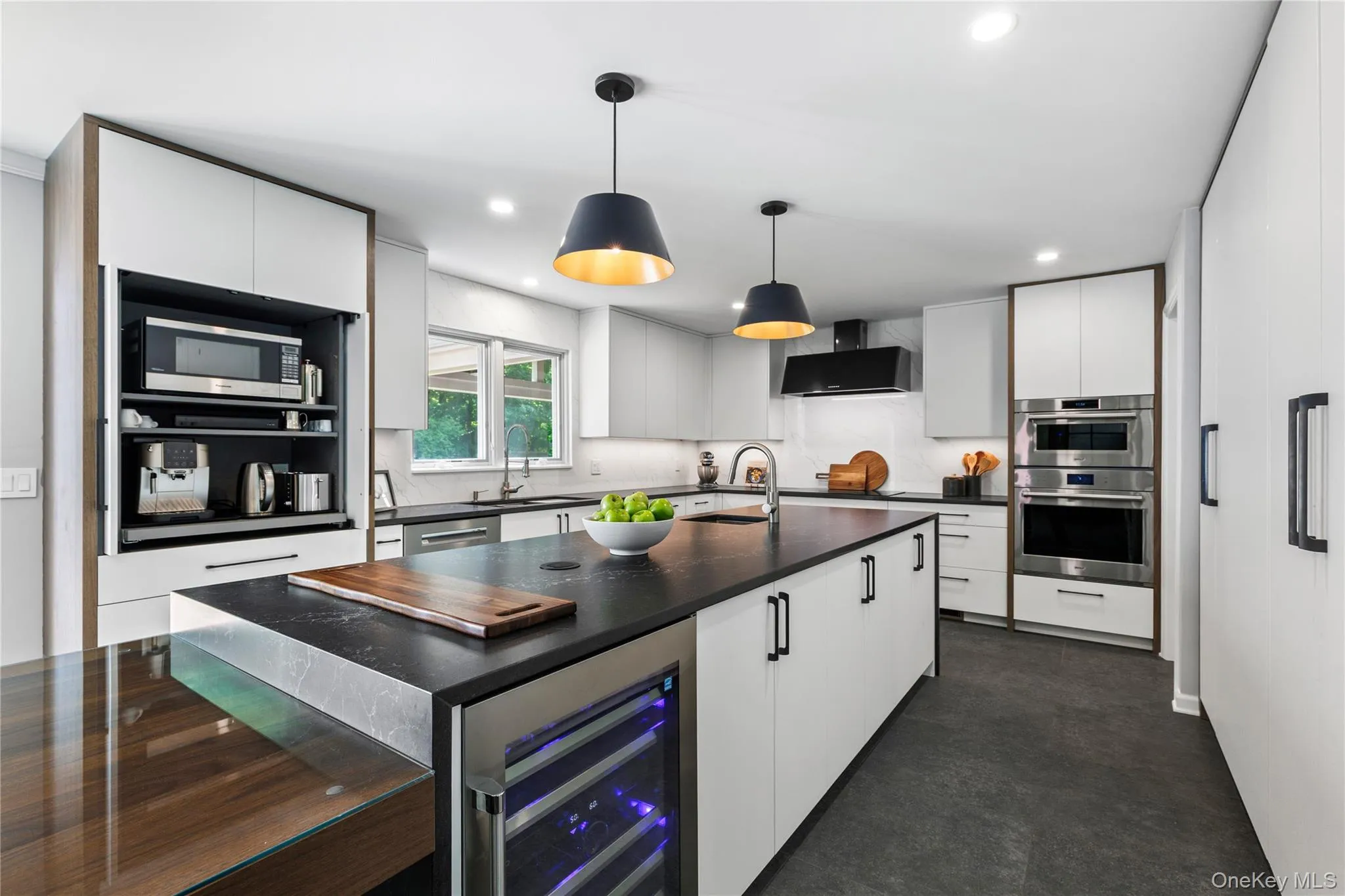 The top-of-the-line, stainless steel elements and the strategic appliance garage make this kitchen a high performance culinary hub. The top-of-the-line, stainless steel elements and the strategic appliance garage make this kitchen a high performance culinary hub.