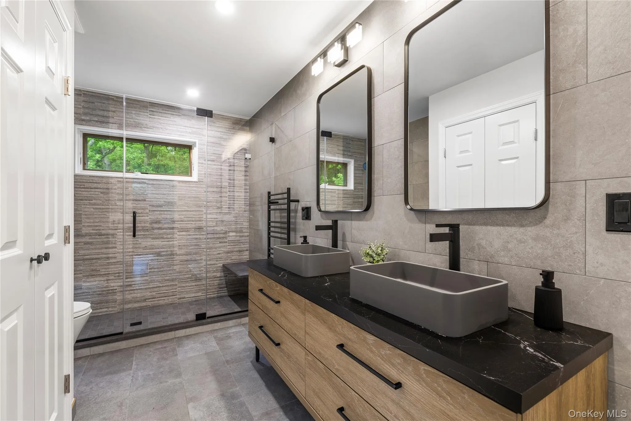 The Jack & Jill bathroom is vast with its stall shower, double vanity, storage drawers and medicine closet. The Jack & Jill bathroom is vast with its stall shower, double vanity, storage drawers and medicine closet.