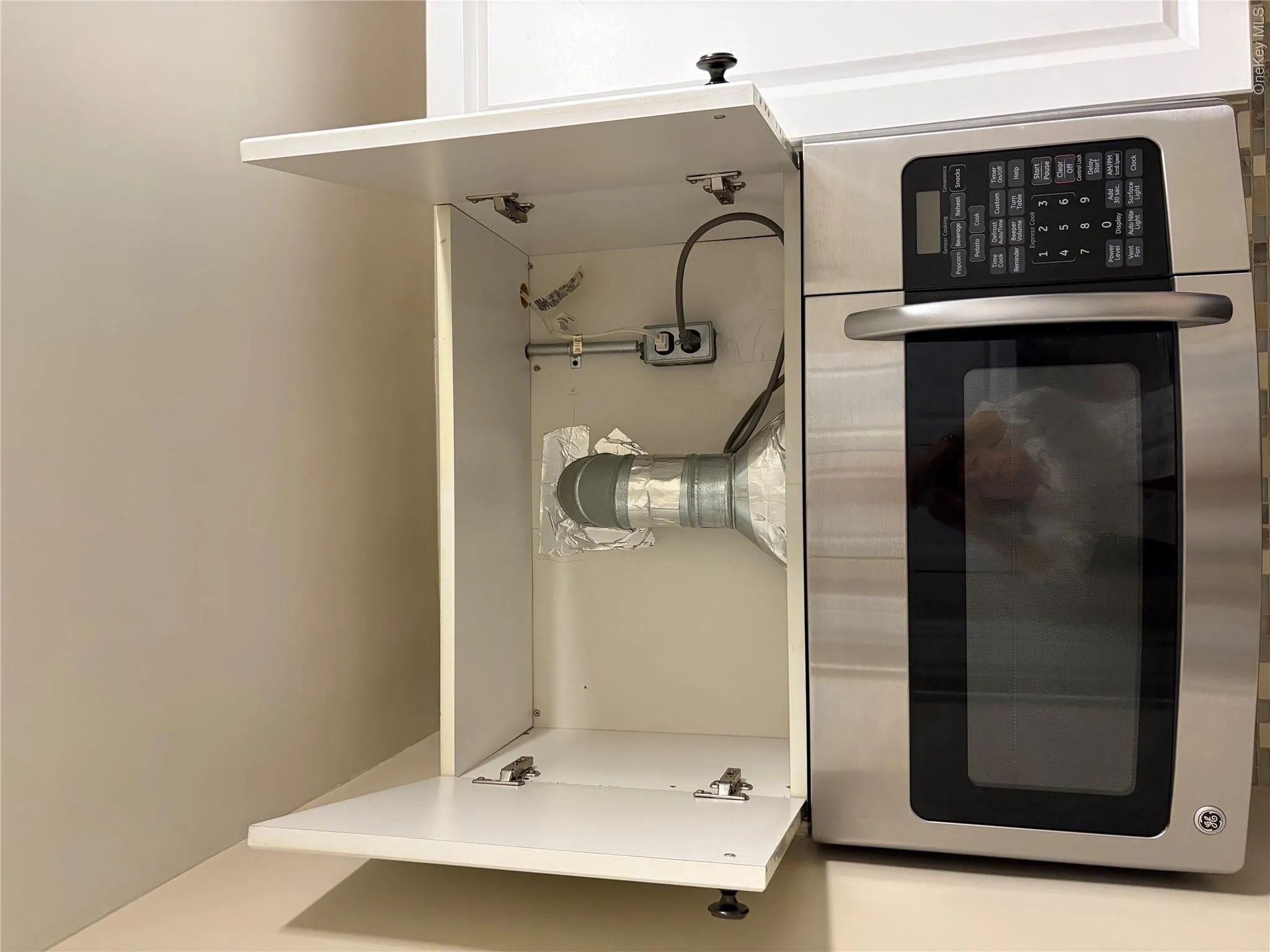 Vent from Microwave is Connected to Building Vent Vent from Microwave is Connected to Building Vent